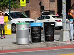 The new bins (middle and right) were piloted in the Flushing neighborhood of Queens this past summer. (Courtesy of NYC Department of Sanitation/Group Project)
