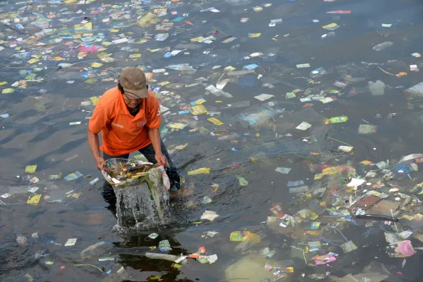 Swimming with sacks in Manila Bay.
