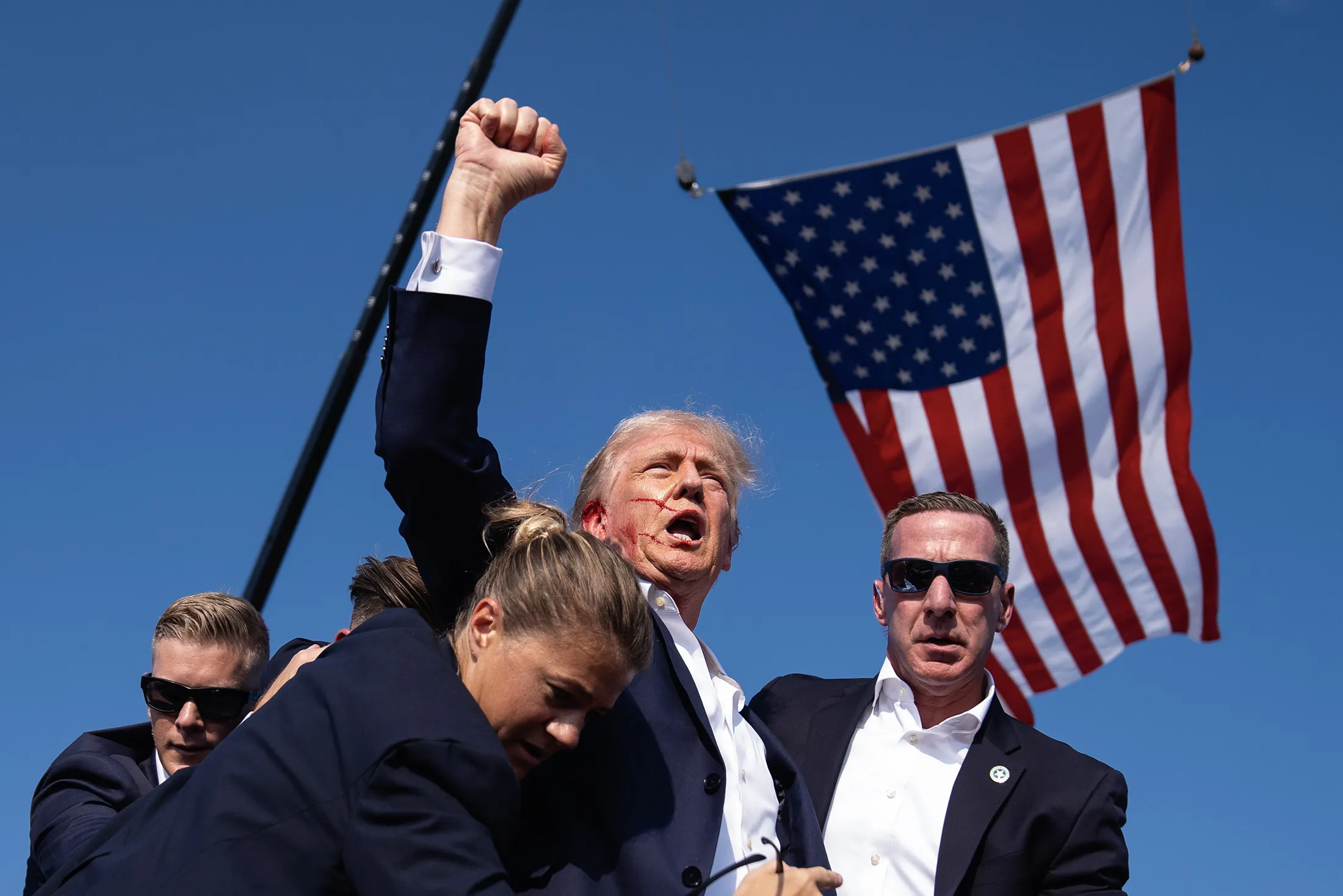 Donald Trump gesturing after he was shot in the right ear after gunfire erupted at a rally in Butler, Pennsylvania, on July 13. 