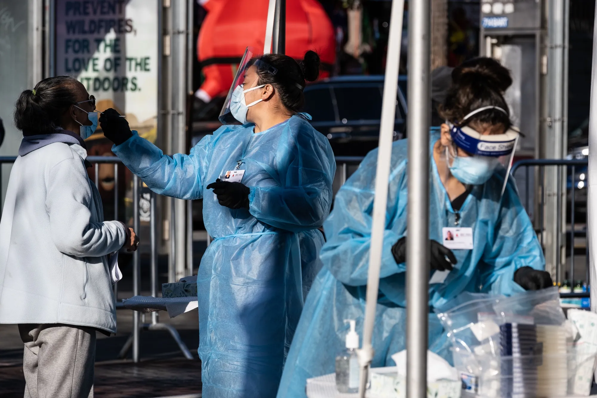 Healthcare workers administer tests at a Covid-19 testing tent outside a Bay Area Rapid Transit (BART) station in the Mission District of San Francisco.