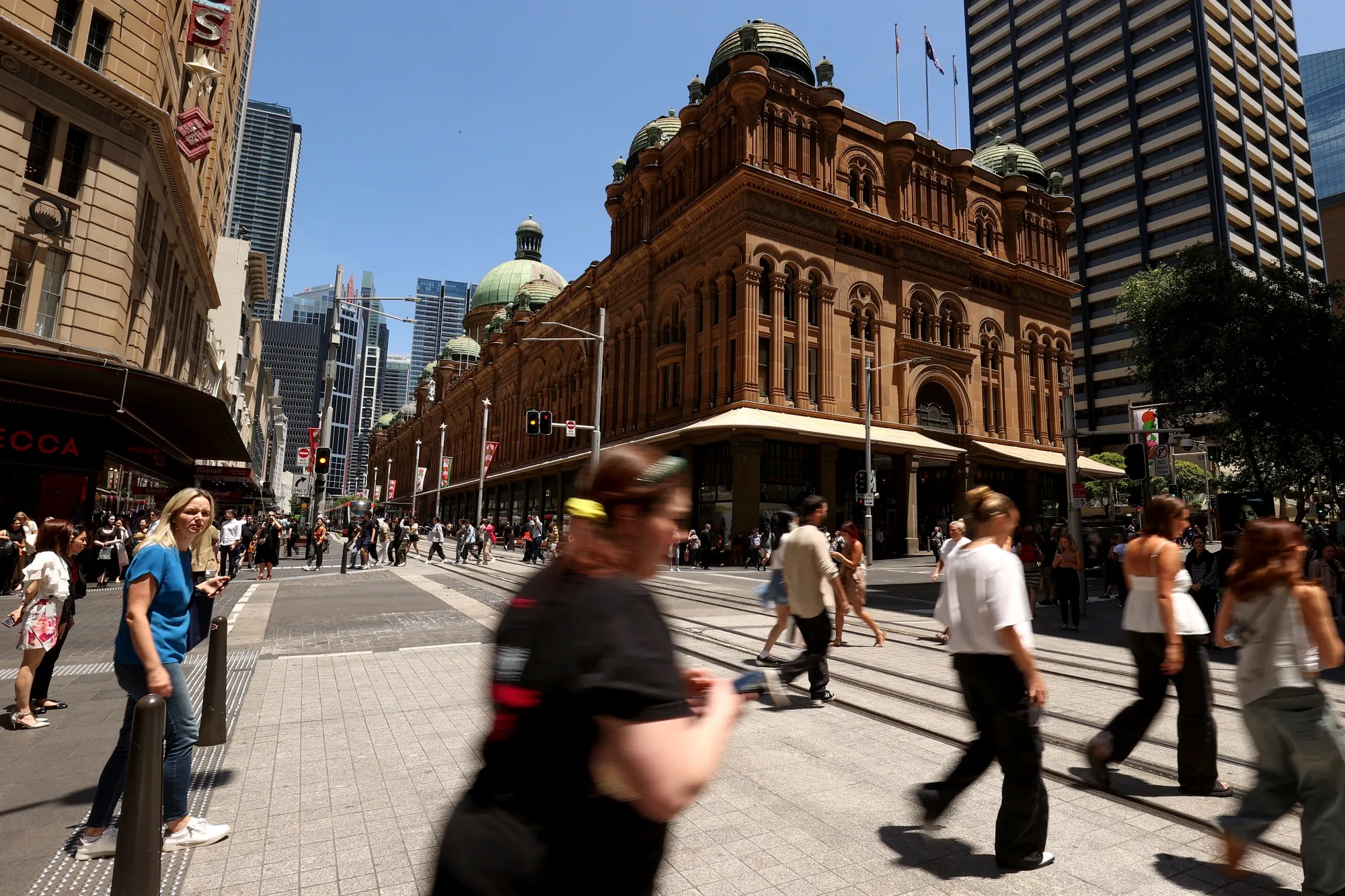 Pedestrians walk past the Queen Victoria Building shopping arcade in Sydney.