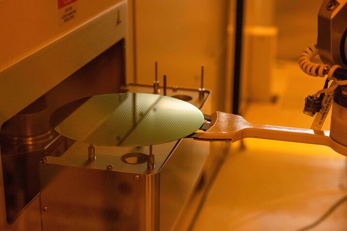 A robotic arm moves a silicon semiconductor at a wafer fab owned by Nexperia.