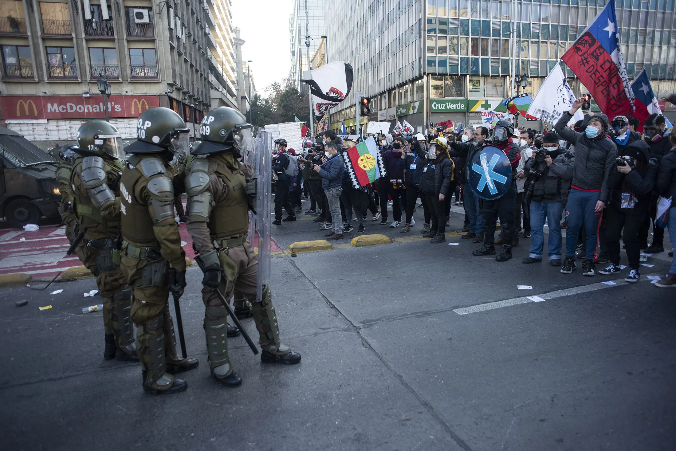 Demonstrators clash with riot police during the opening session of the Constitutional Convention in Santiago, Chile, on July 4.