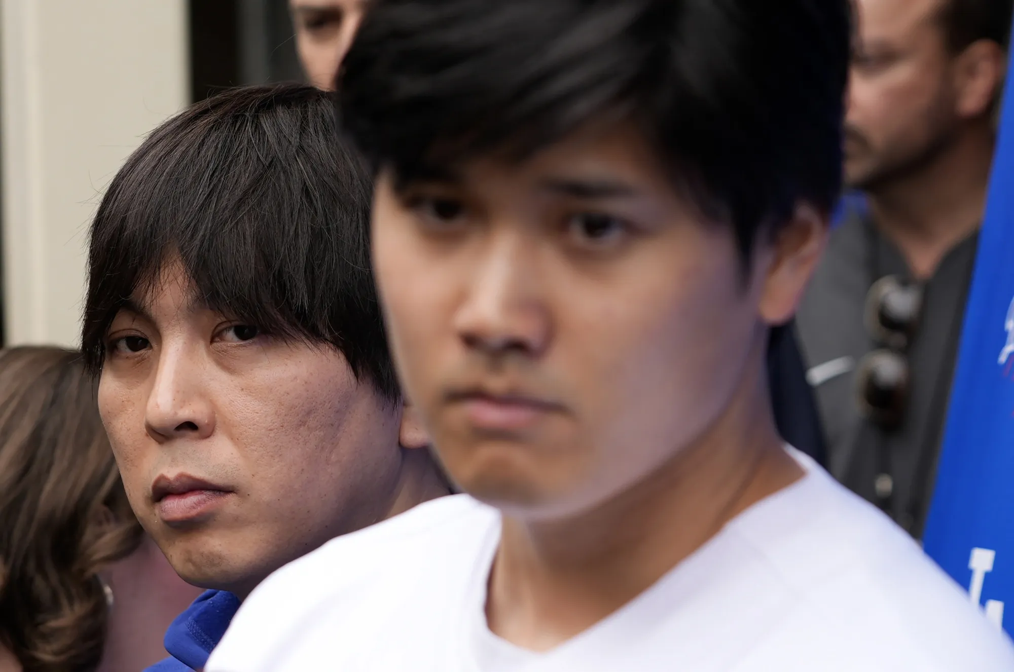 Ippei Mizuhara stands next to&nbsp;Shohei Ohtani during an interview.