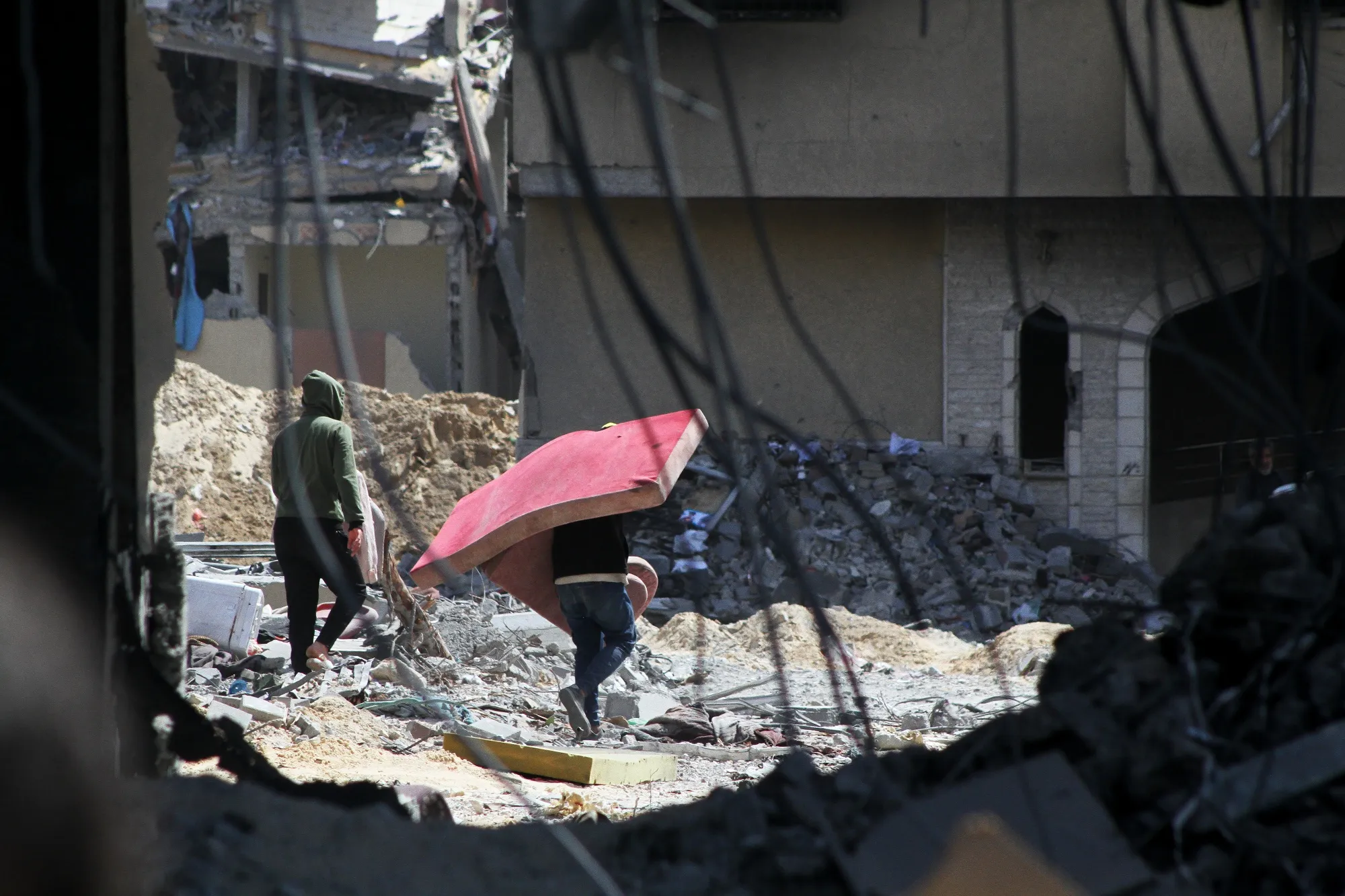 Palestinians recover possessions from destroyed buildings in Gaza.