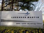 Trees surround a sign for Lockheed Martin Corp. standing outside the company's headquarters in Bethesda, Maryland, U.S.
