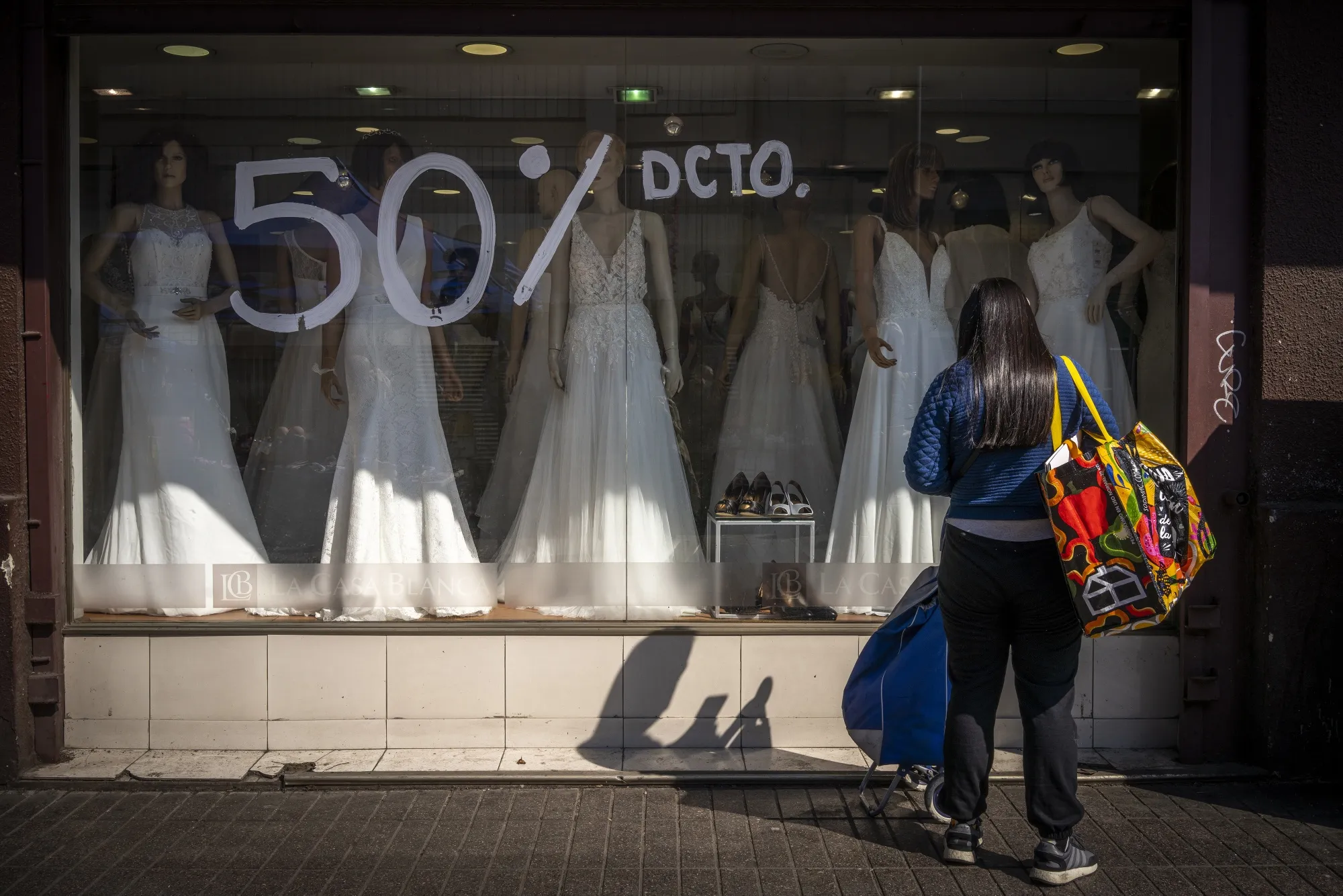 Wedding dresses in a shop window in Santiago.