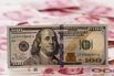 Yuan And Dollar Banknotes Ahead Of Tenth Anniversary Of China's Yuan Reform