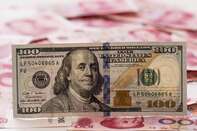 Yuan And Dollar Banknotes Ahead Of Tenth Anniversary Of China's Yuan Reform