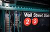 Commuters exit a Wall Street subway station near the New York Stock Exchange.