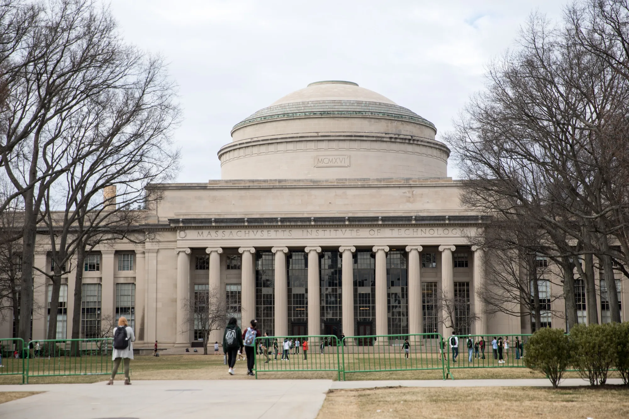 Pedestrians walk at the Massachusetts Institute of Technology in Cambridge on March 10.