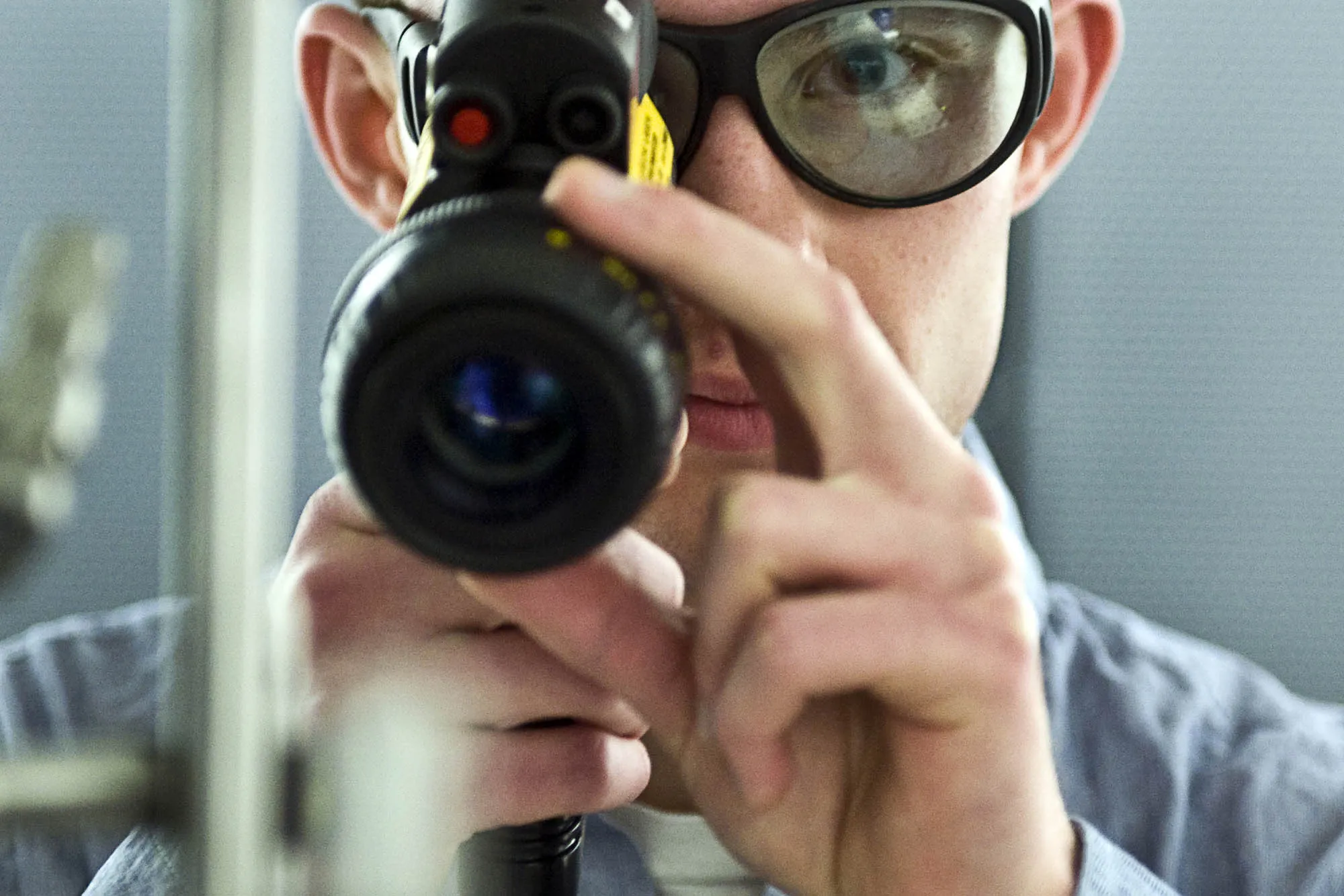 A man poses with a scope at a Physical Measurement Lab that deals with quantum computing and simulation in Gaithersburg, Maryland.
