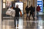 A shopper carries bags inside the Westfield San Francisco Centre shopping mall on Wednesday, Dec. 22, 2021.