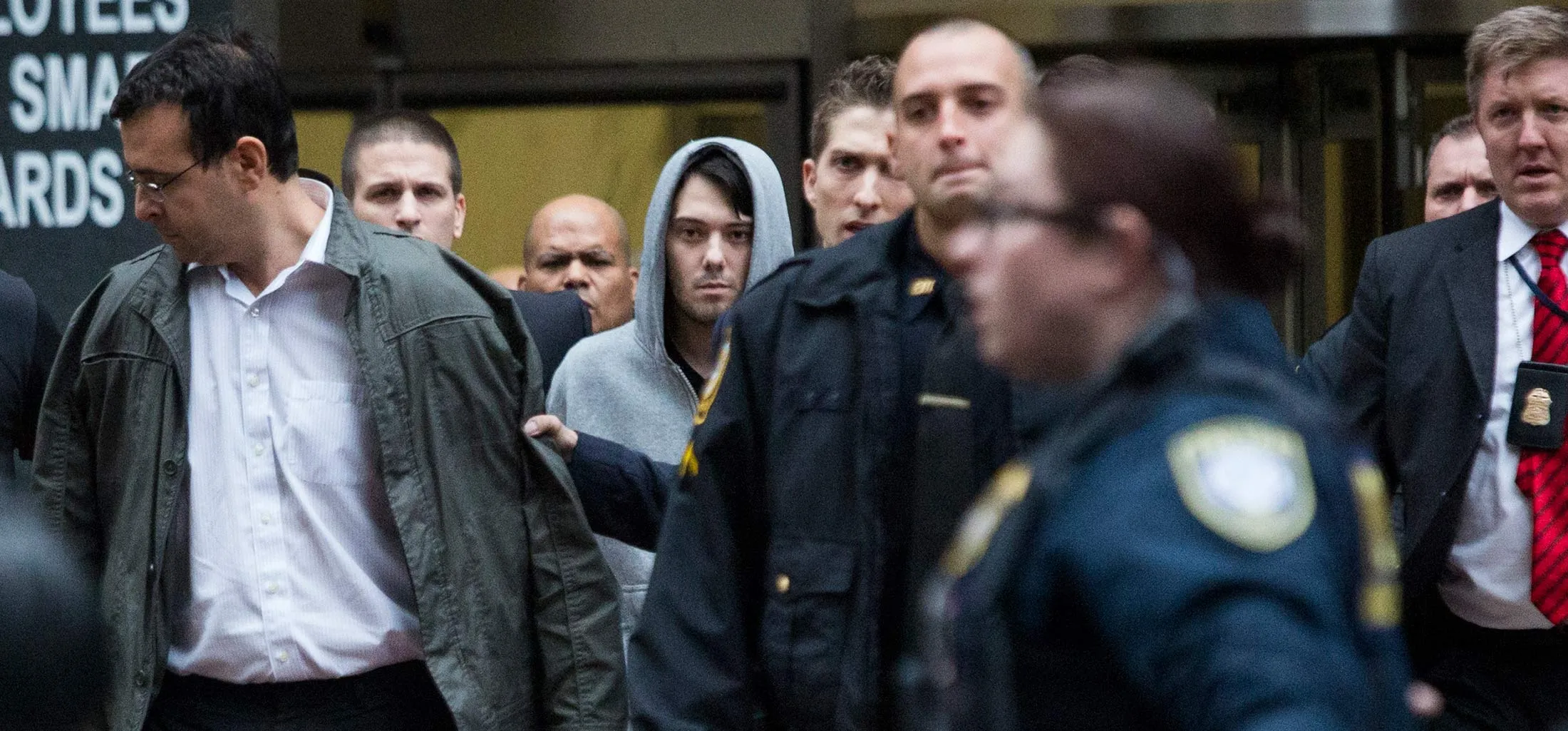 Martin Shkreli, chief executive officer of Turing Pharmaceuticals LLC, center, and attorney Evan Greebel, left, exit federal court in New York, U.S., on Thursday, Dec. 17, 2015. Shkreli was arrested on alleged securities fraud related to Retrophin Inc., a biotech firm he founded in 2011. Greebel is accused of conspiring with Shkreli in part of the scheme.
