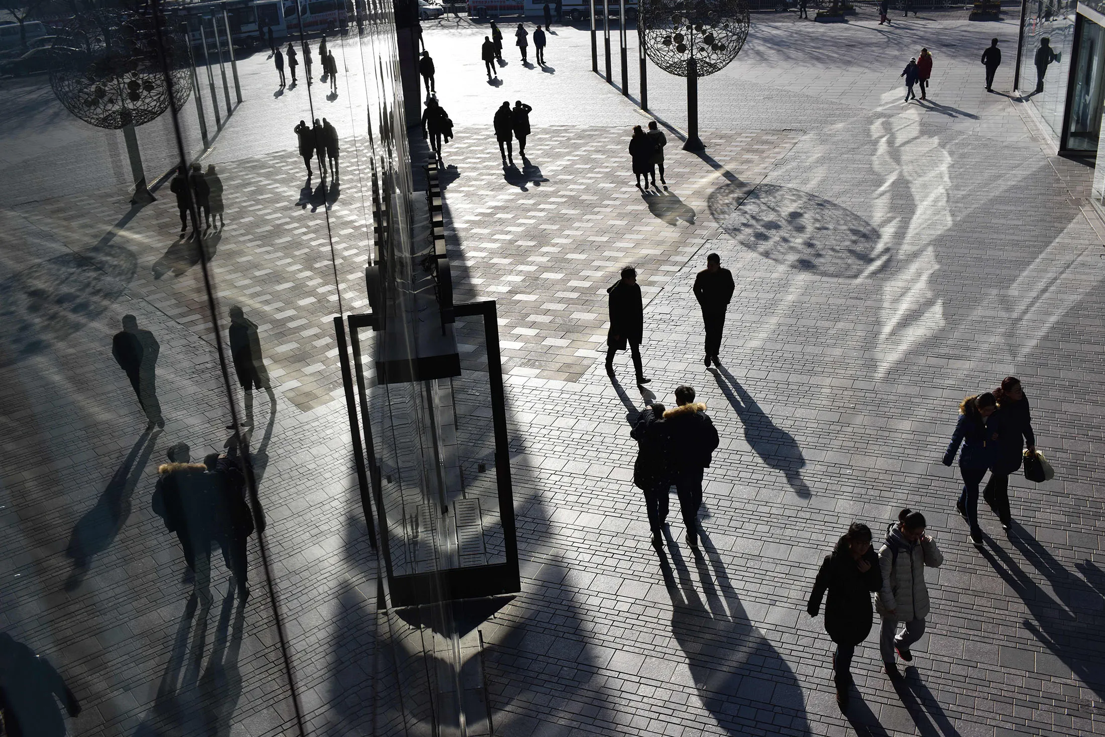 People walk outside a shopping mall in Beijing.&nbsp; &nbsp;