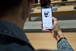 A customer tries out the Animoji feature on an Apple iPhone X.