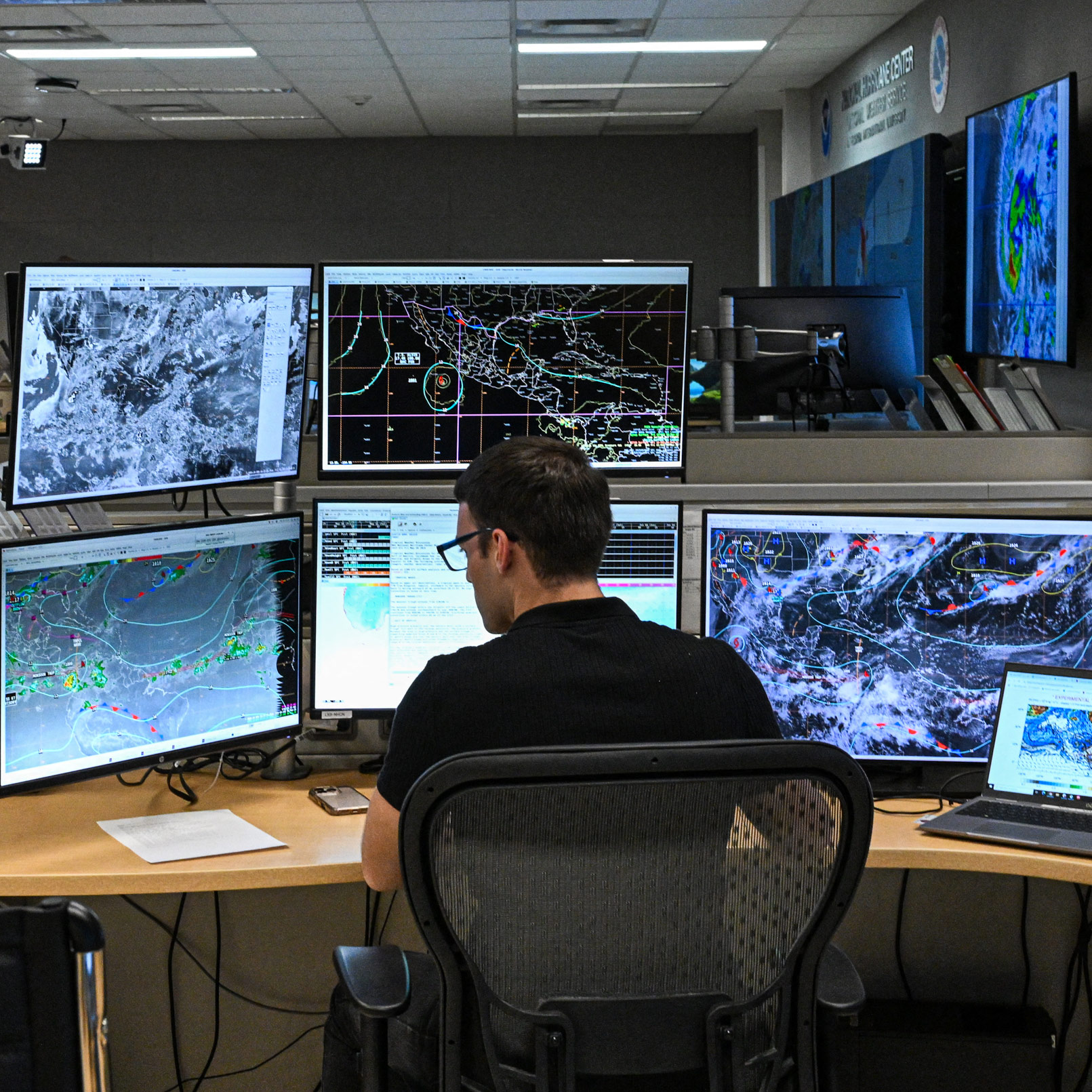 Tropical analysis meteorologist works at his station at the National Oceanic and Atmospheric Administration's (NOAA) National Hurricane Center in Miami, Florida, on May 30, 2025.