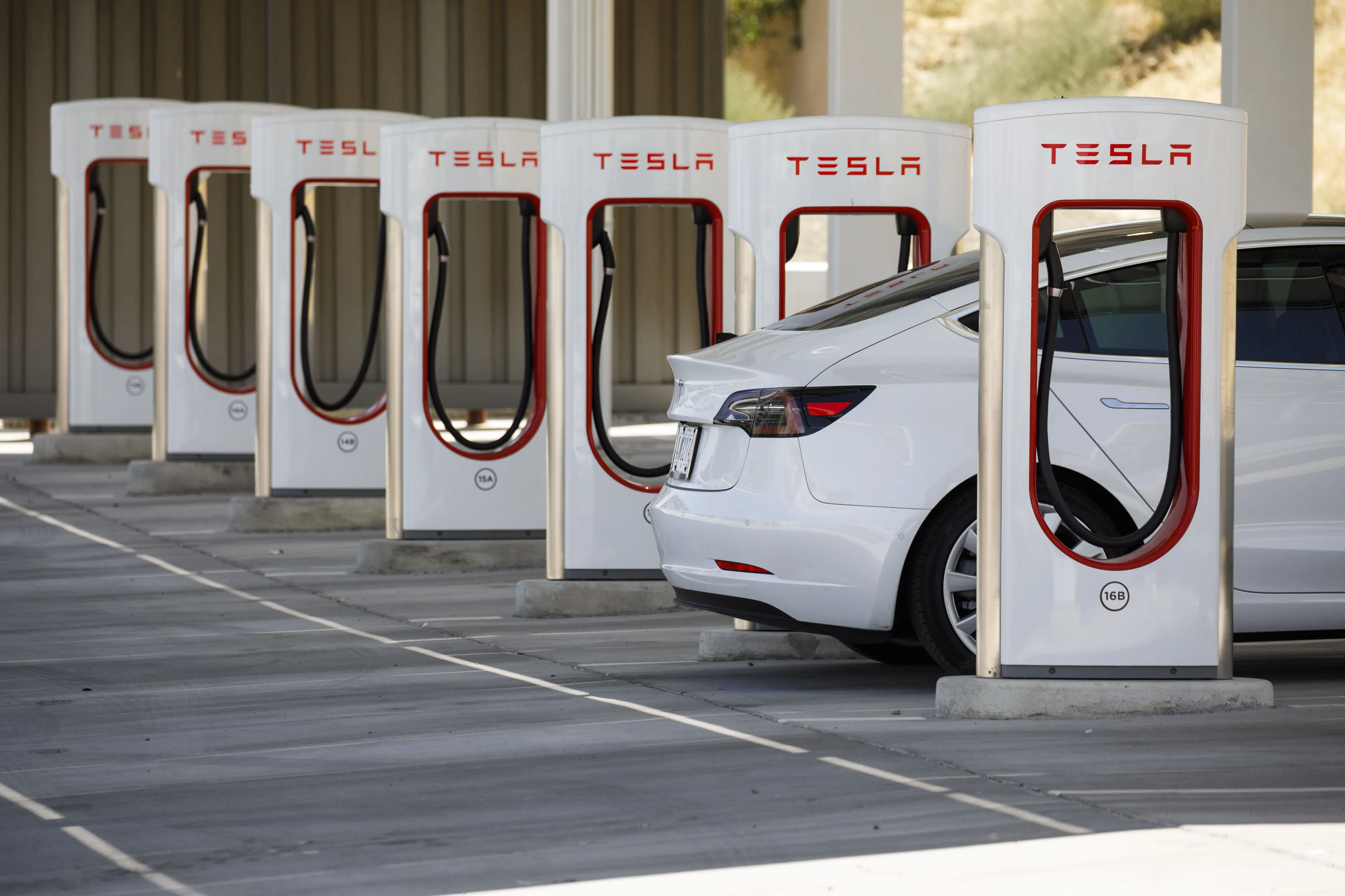 A Tesla Model 3 at a Supercharger station.