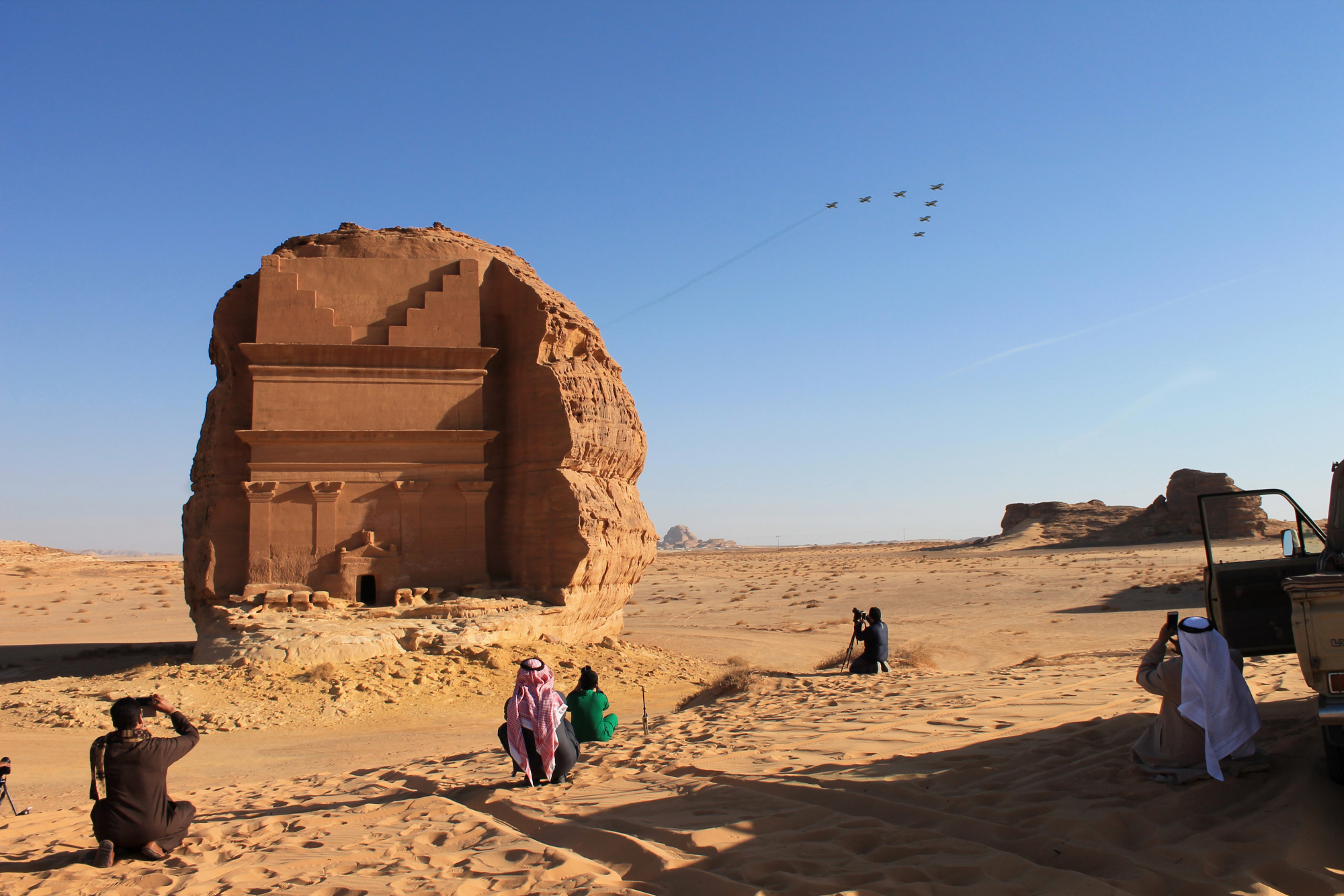 Visitors watch an aerial flying display over Mada'in Saleh, a UNESCO World Heritage Site, in Mada'in Saleh.