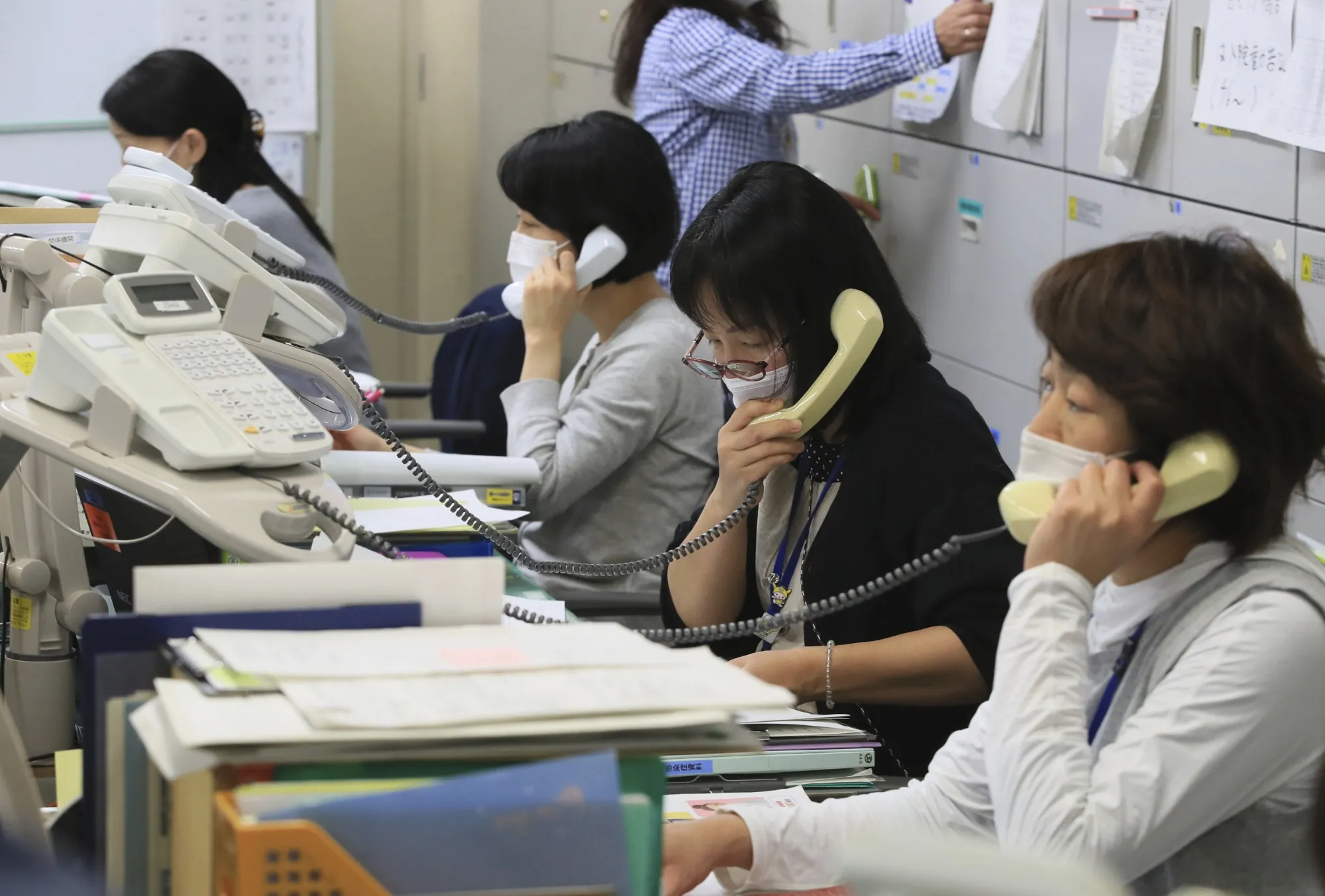 Public health nurses conduct contact tracing at the Ota Ward health center in Tokyo on April 27.