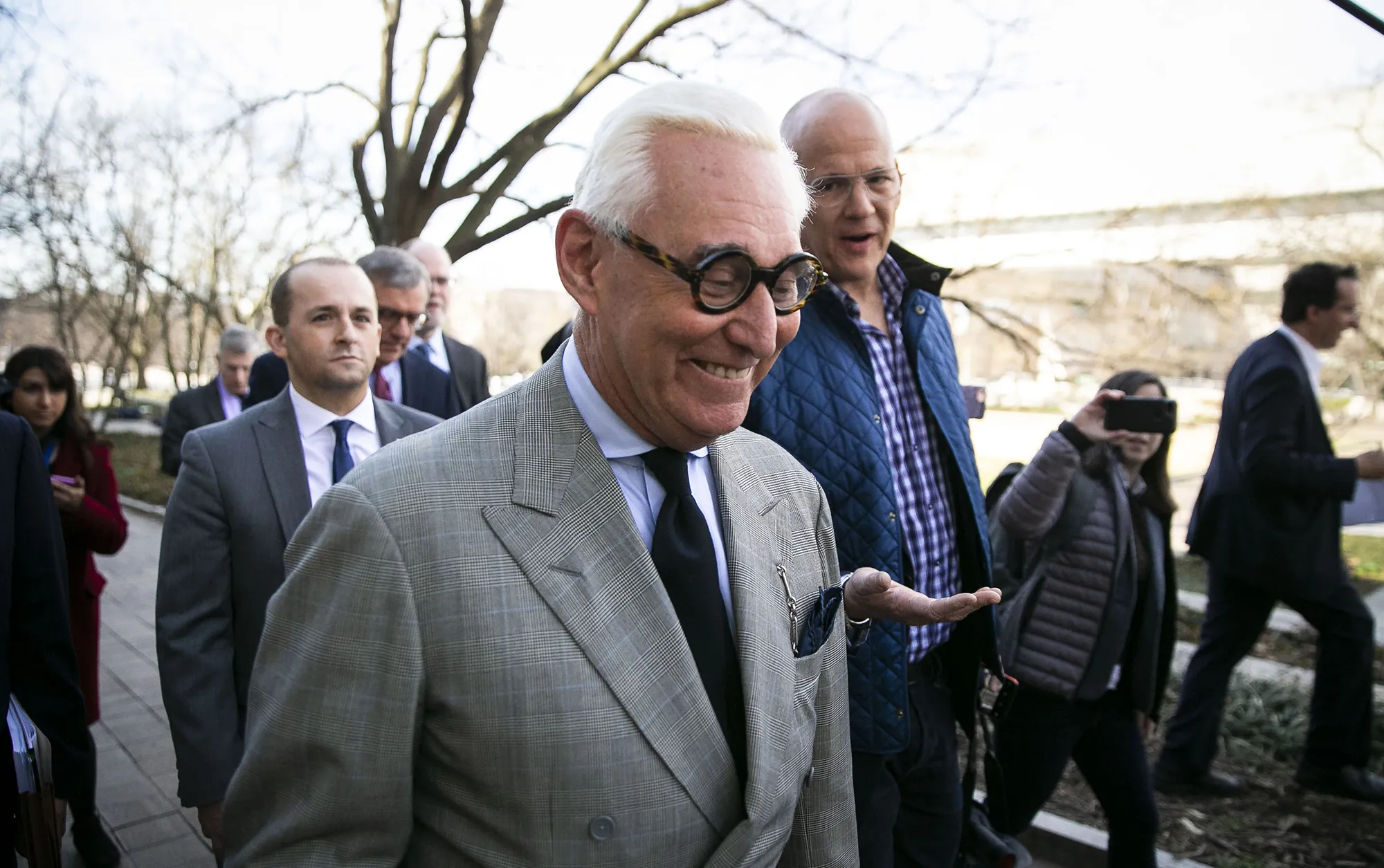 Roger Stone smiles while departing from federal court in Washington, D.C. in 2019.