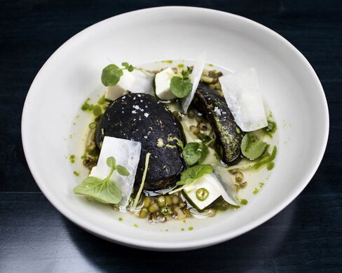 The charred avocado is served warm in a pool of tomato water and mung beans. The vegan version involves no cheese, and it still shines.