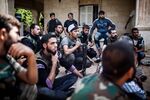 Rebel fighters listen to their commander at a base in Tal Rifaat, Syria, before departing for the front line in Aleppo on Aug. 15