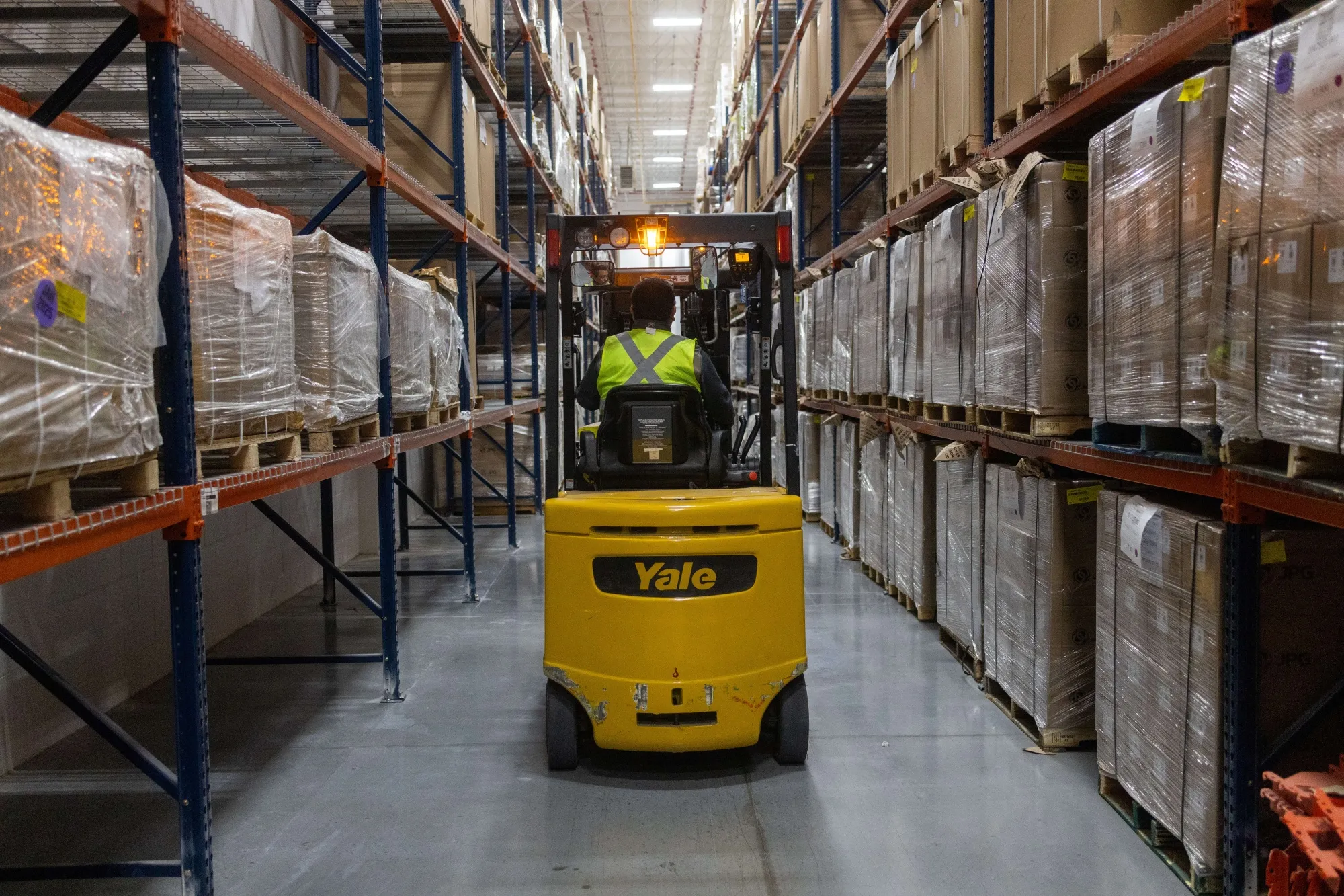 A worker operates a forklift to sort packaged goods destined for export, at a warehouse along the US-Mexico border in Ciudad Juarez, Chihuahua state, Mexico.