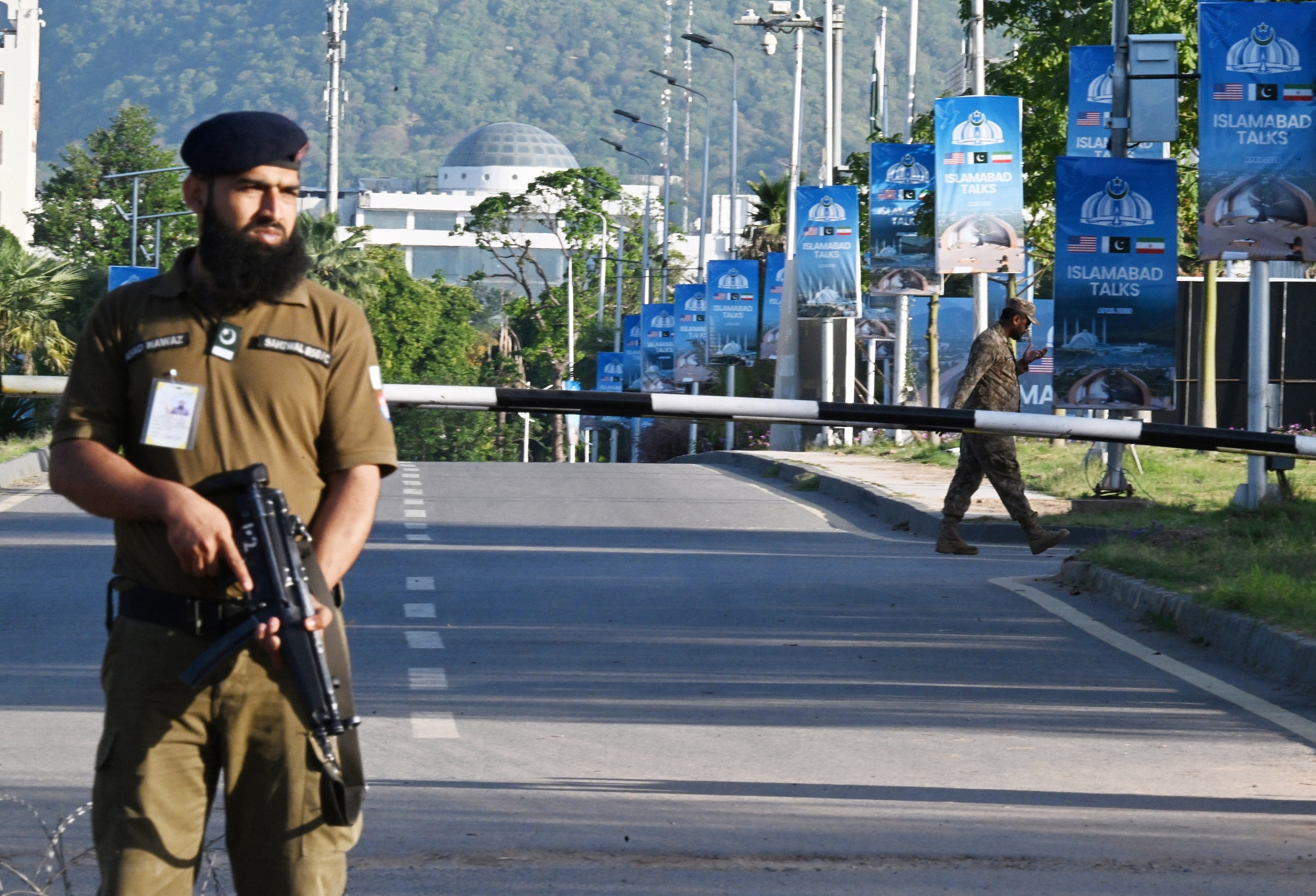 Security personnel guard a checkpoint near the Serena Hotel in Islamabad, on April 22. Photographer: Aamir Qureshi/AFP/Getty Images
