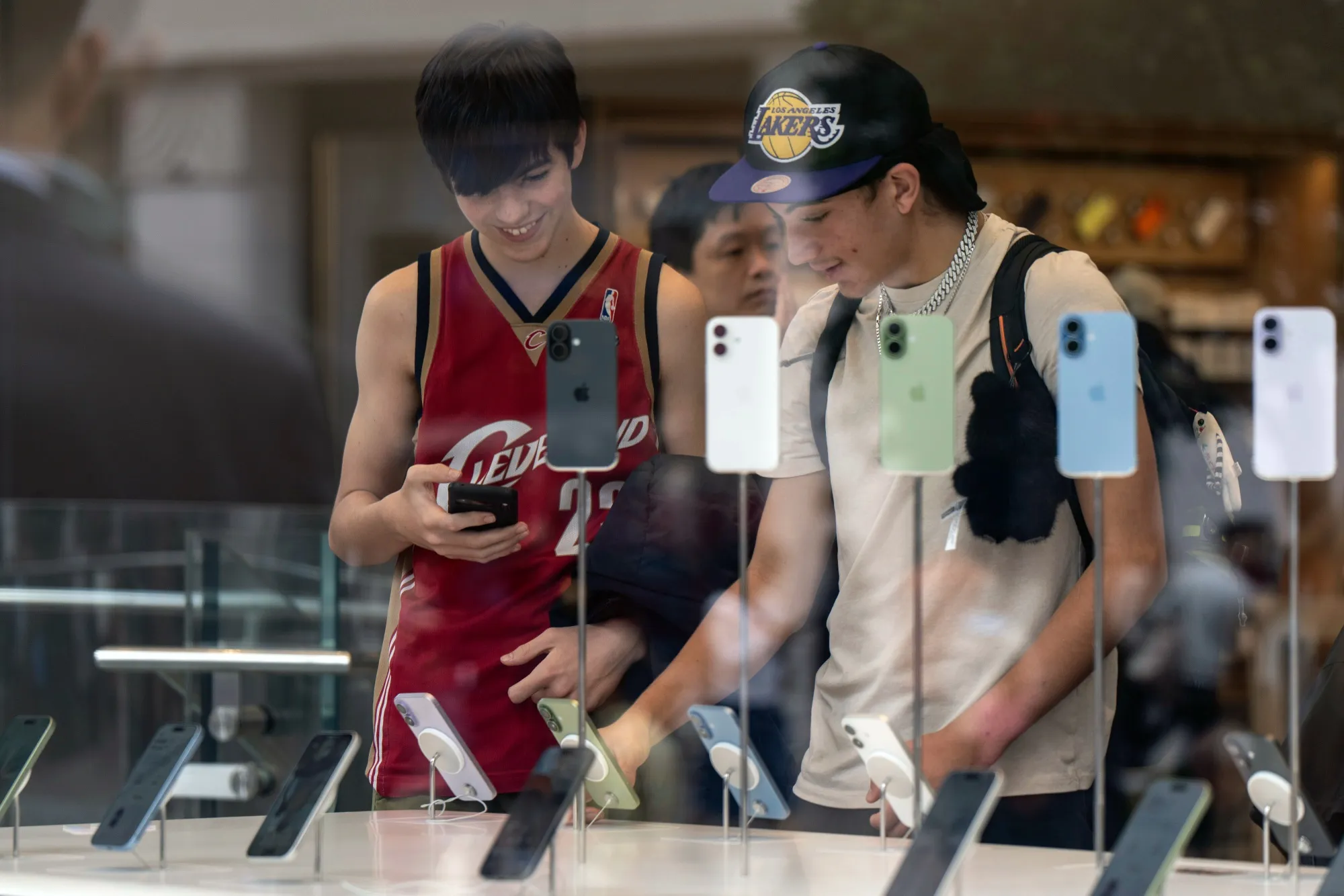 Customers look at Apple Inc. iPhone 17 series smartphones at one of the company's stores&nbsp;in Shanghai, China.