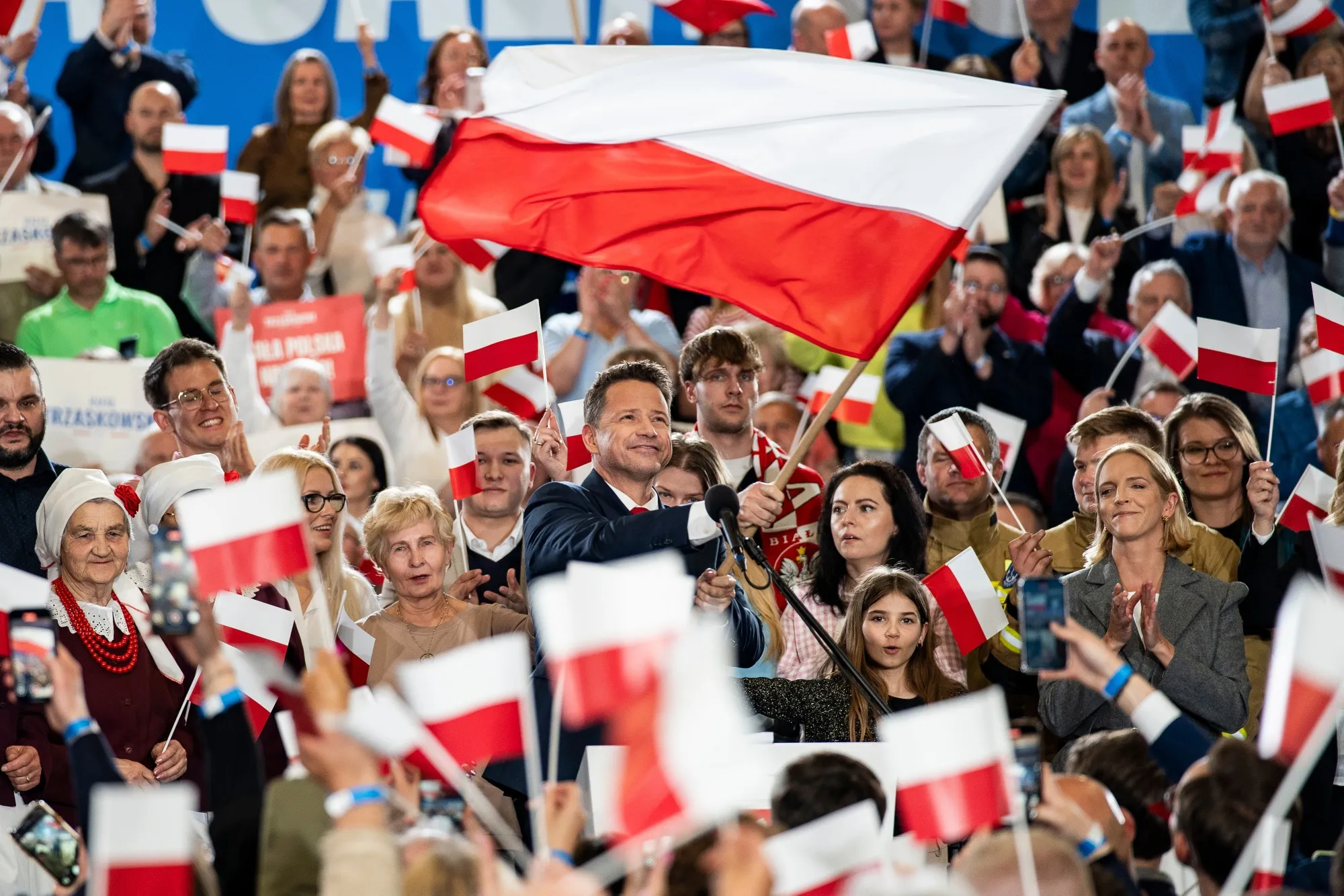 Rafal Trzaskowski waves a Polish flag during an election night rally in Sandomierz, Poland, on Sunday.