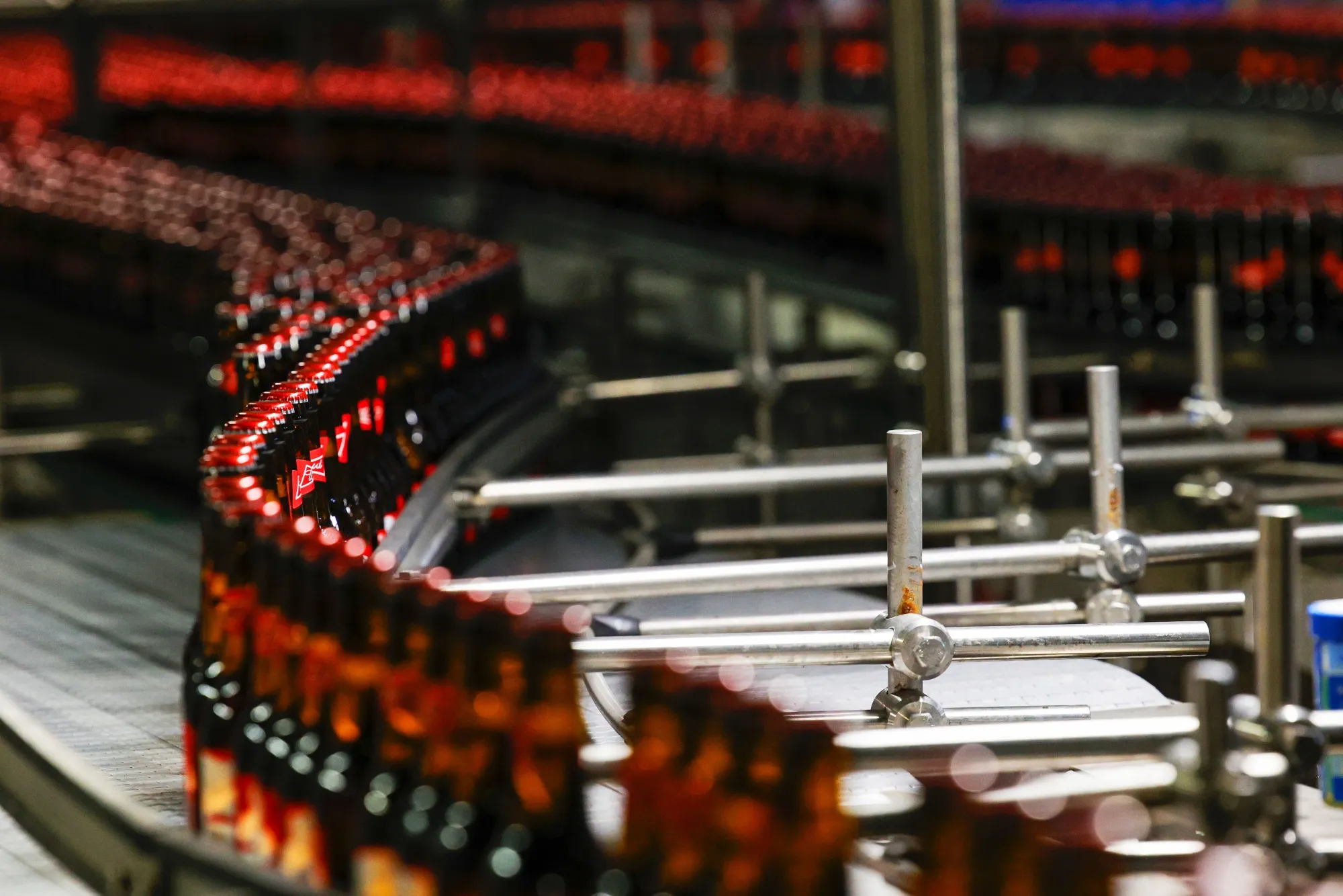 Bottles of Budweiser beer on conveyors at the Anheuser-Busch InBev NV brewery in Leuven, Belgium.
