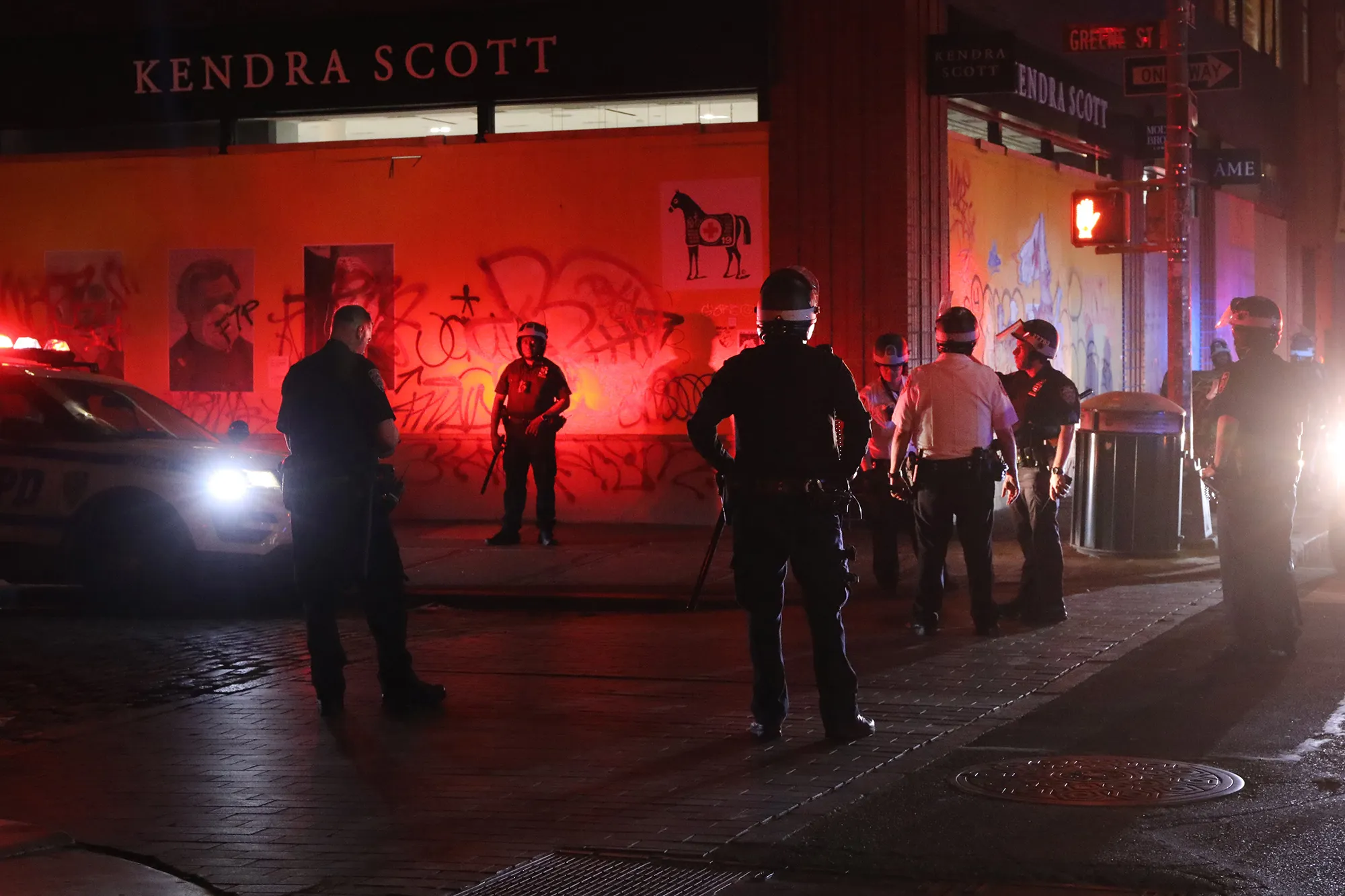 NYPD officers stand guard near looted stores in New York City, on June 1.