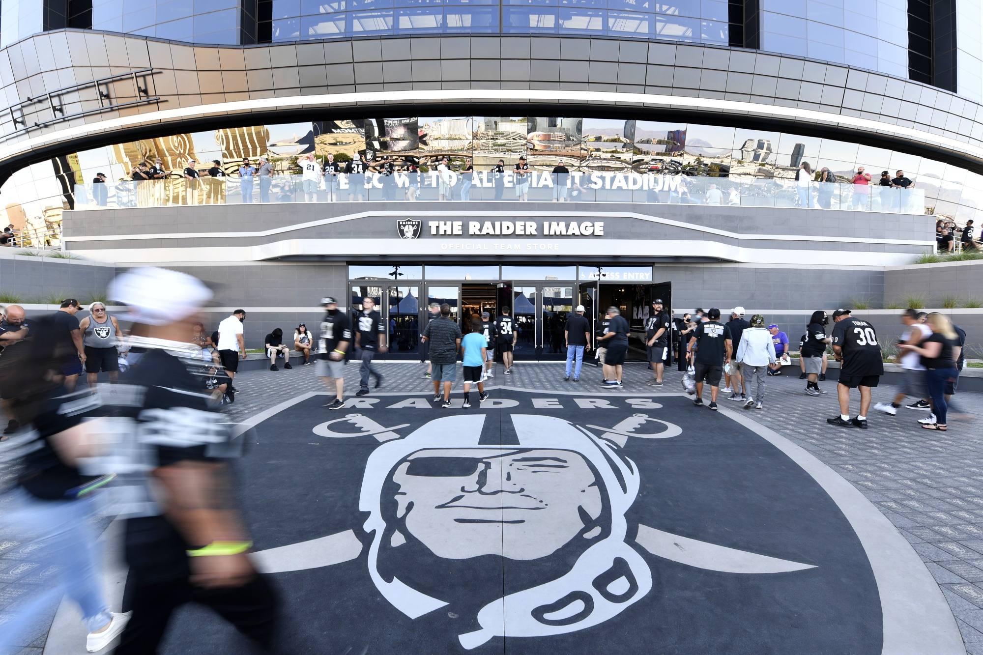 Fans arrive at Allegiant Stadium before a Las Vegas Raiders game in Las Vegas.