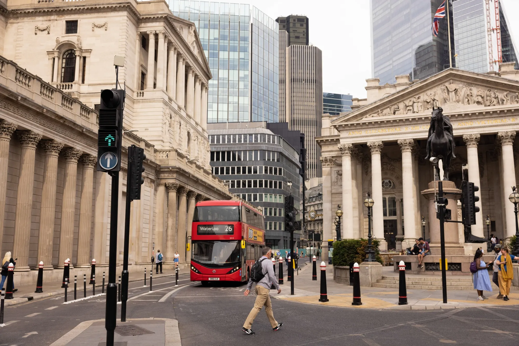 A worker crosses the road outside the Bank of England in The City of London, UK.