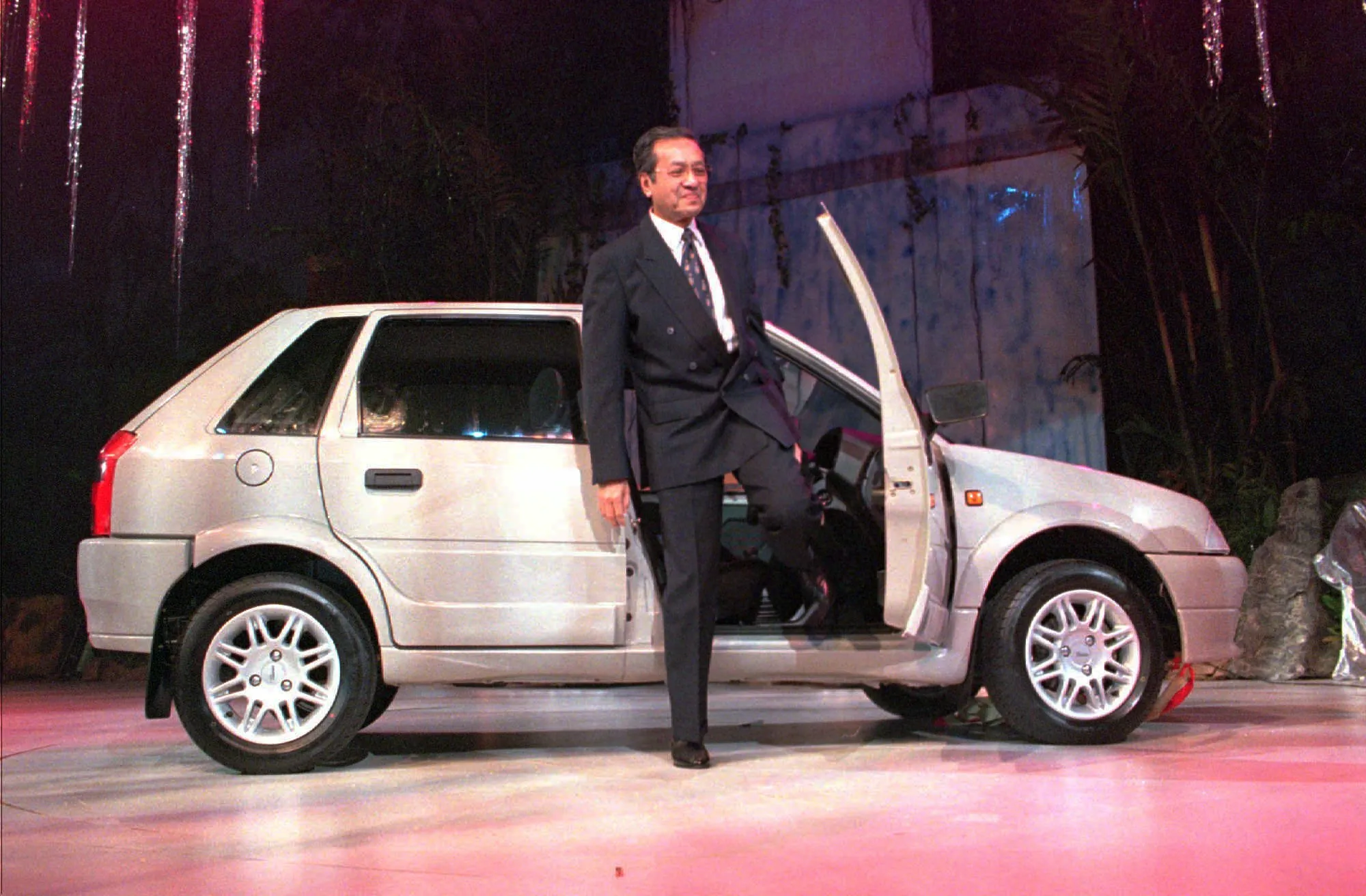 Mahathir steps out of the Proton Tiarra in 1996.