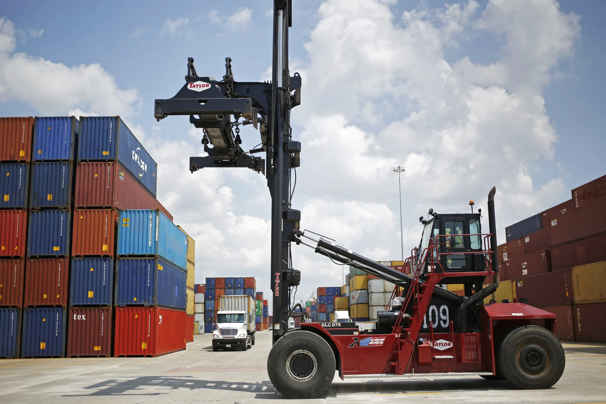 A worker drives a crane through the APM Terminals yard at the Port of Mobile in&nbsp;Alabama&nbsp;in 2017.