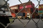 Trucks pull shipping containers at the Port of Los Angeles in San Pedro, California.