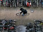 A man rides his bike in a bicycle shed near Central Station Amsterdam. 