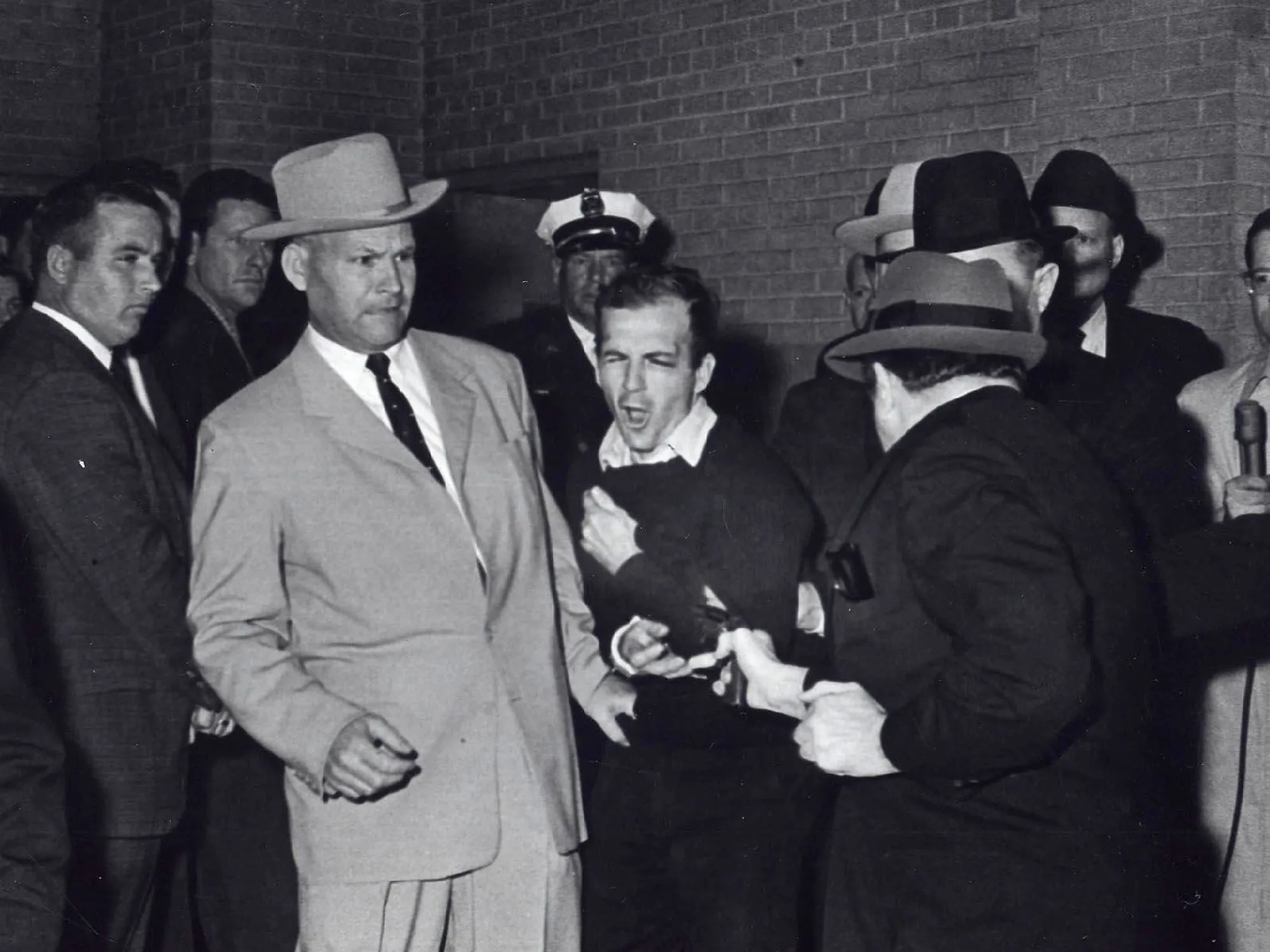 Jim Leavelle, center left, next to Lee Harvey Oswald as Oswald was shot on Nov. 24, 1963.