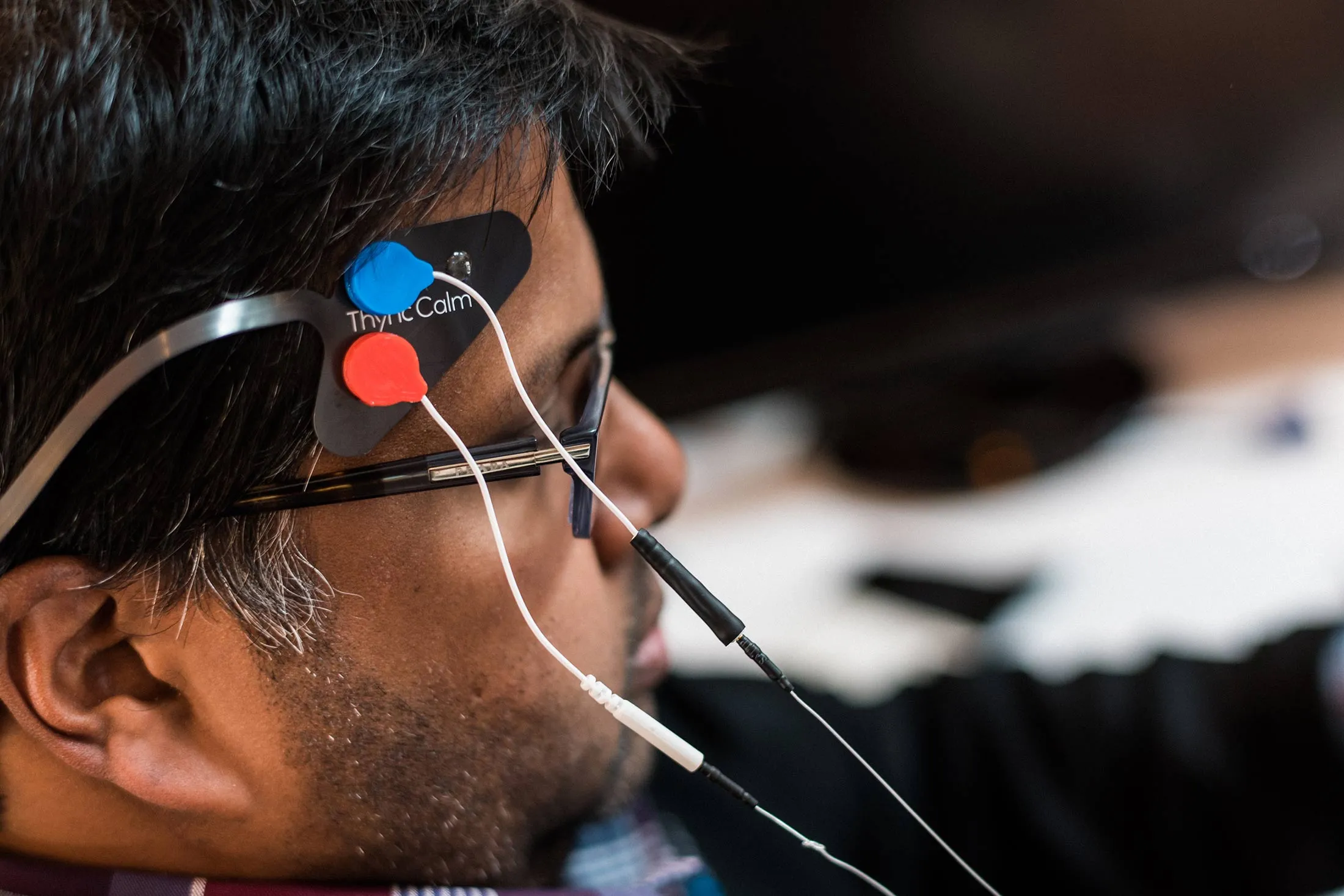 Sumon Pal, former chief of vibes at Thync, tests a prototype Thync module at his desk at Thync's headquarters.

