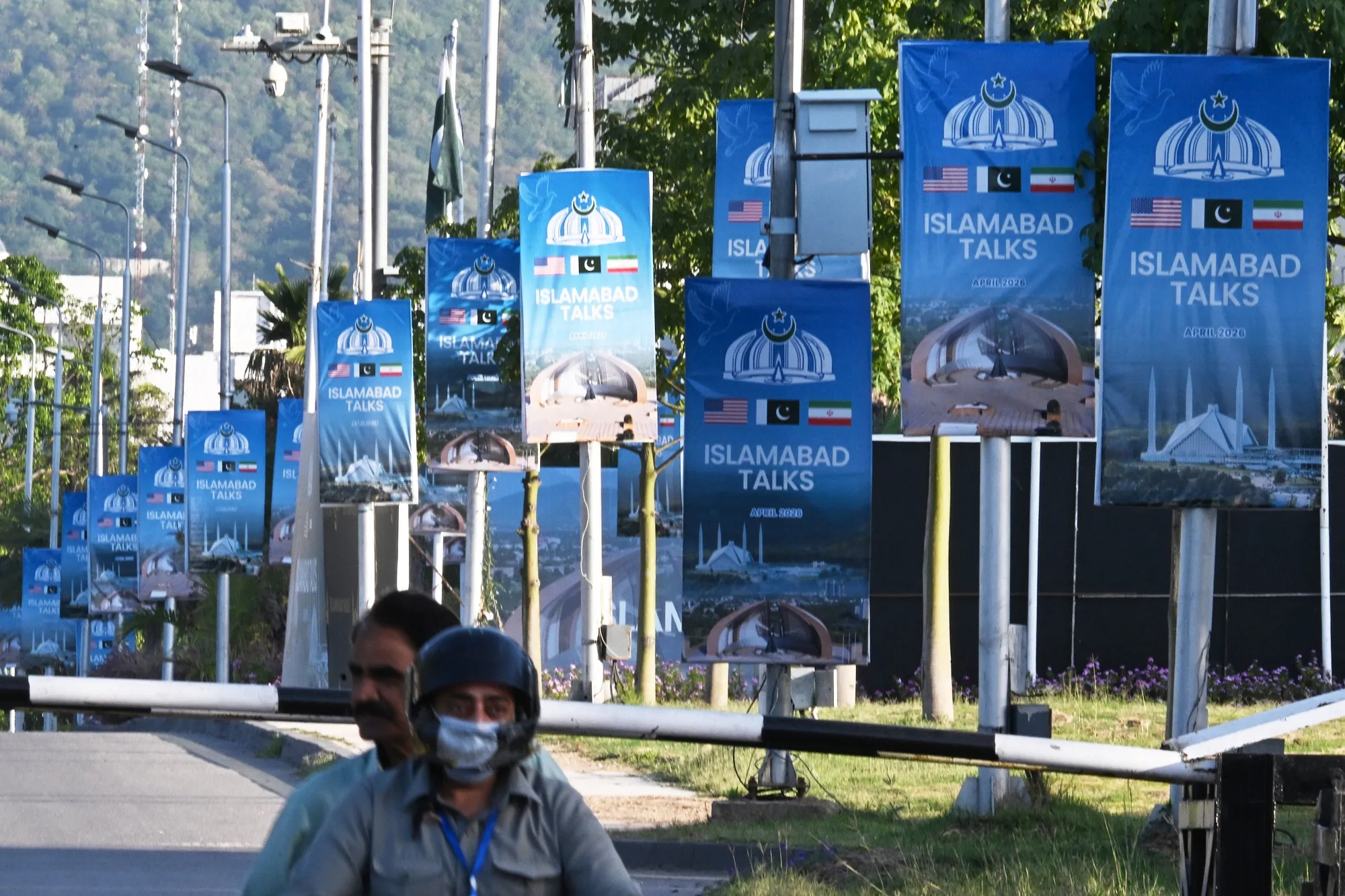 Posters highlighting Pakistan’s mediation of Iran-US peace talks near the Serena Hotel in Islamabad on April 22.