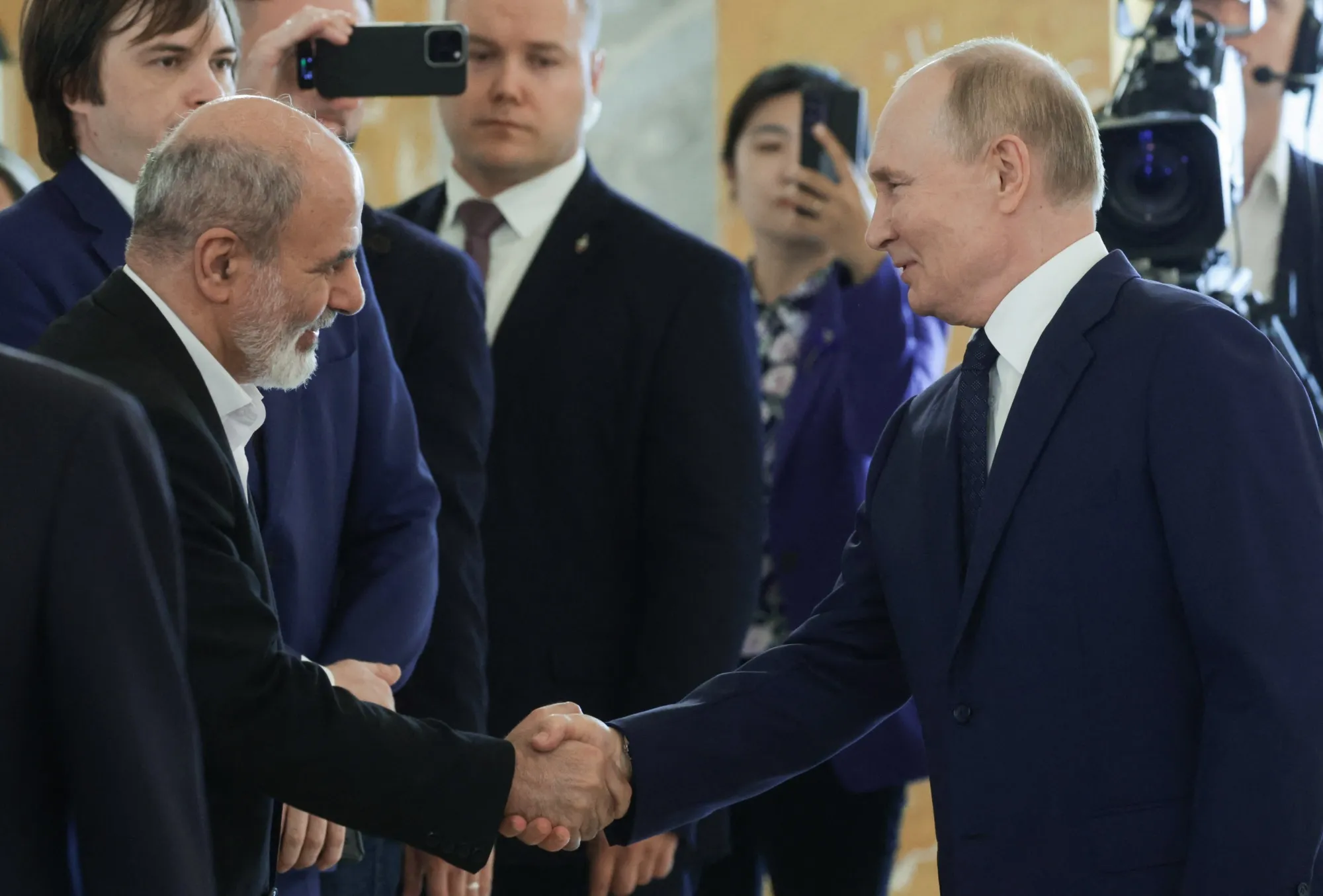 Vladimir Putin shakes hands with Ali Akbar Ahmadian, secretary of Iran's Supreme National Security Council, in Saint Petersburg on September 12, 2024.