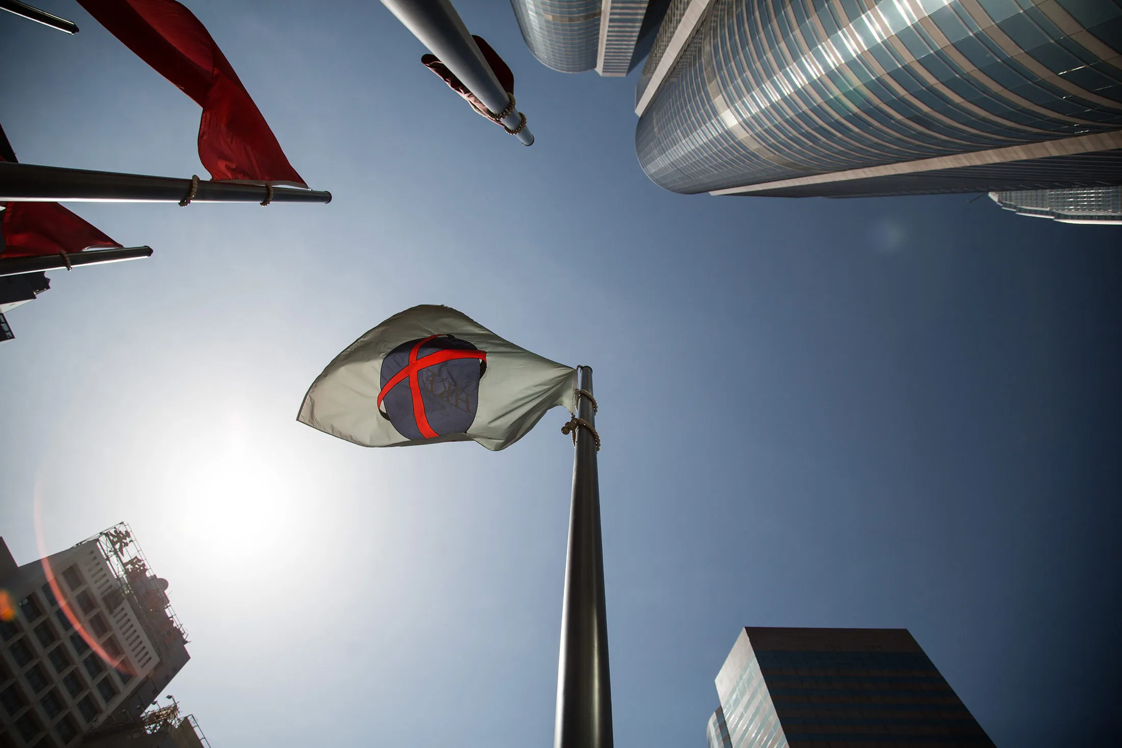 The Hong Kong Exchanges &amp; Clearing Ltd. (HKEx) flag flies outside Exchange Square in Hong Kong, China.
