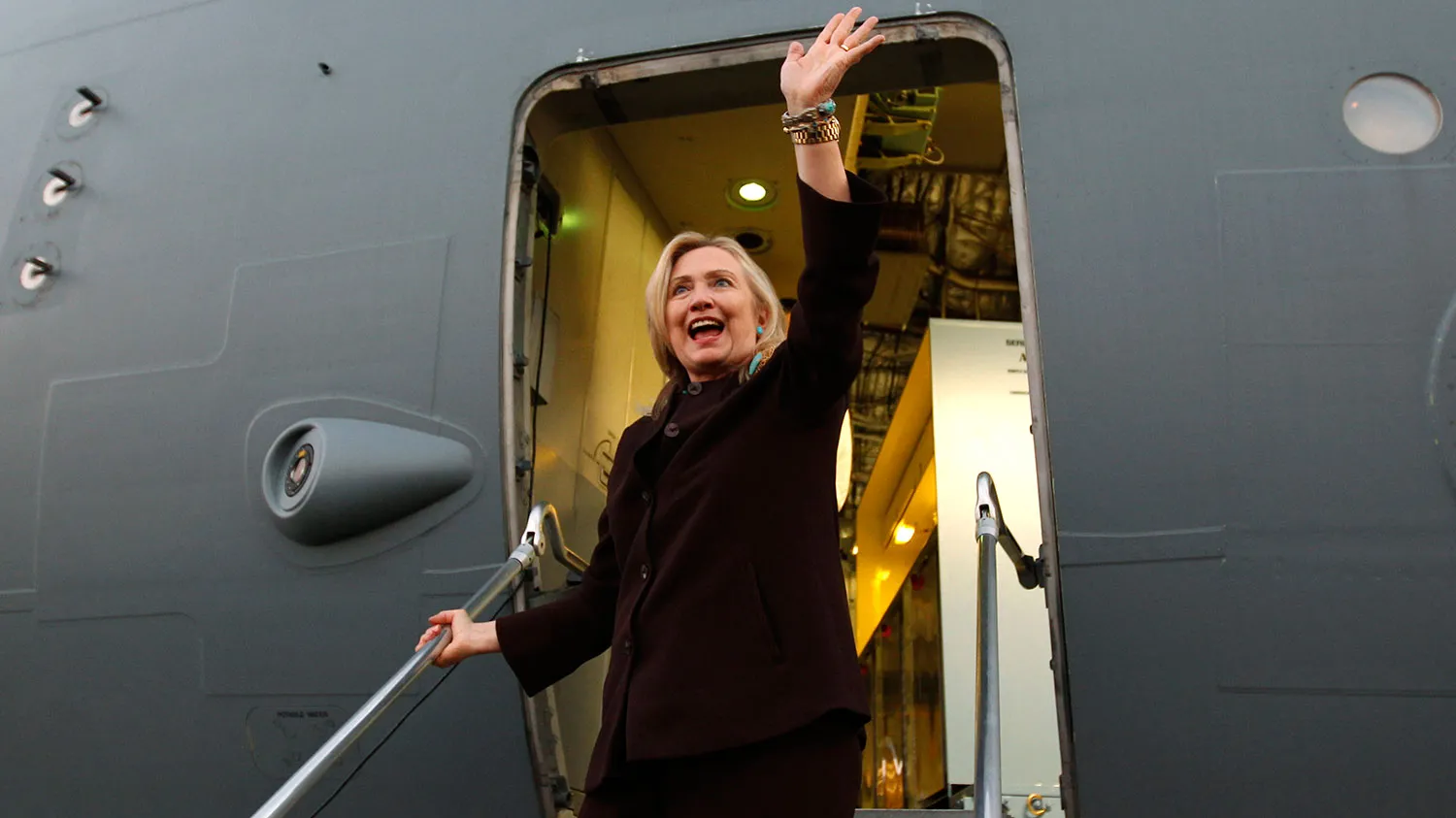 Secretary of State Hillary Clinton waves upon her departure from a visit to Tripoli on Oct. 18, 2011.
