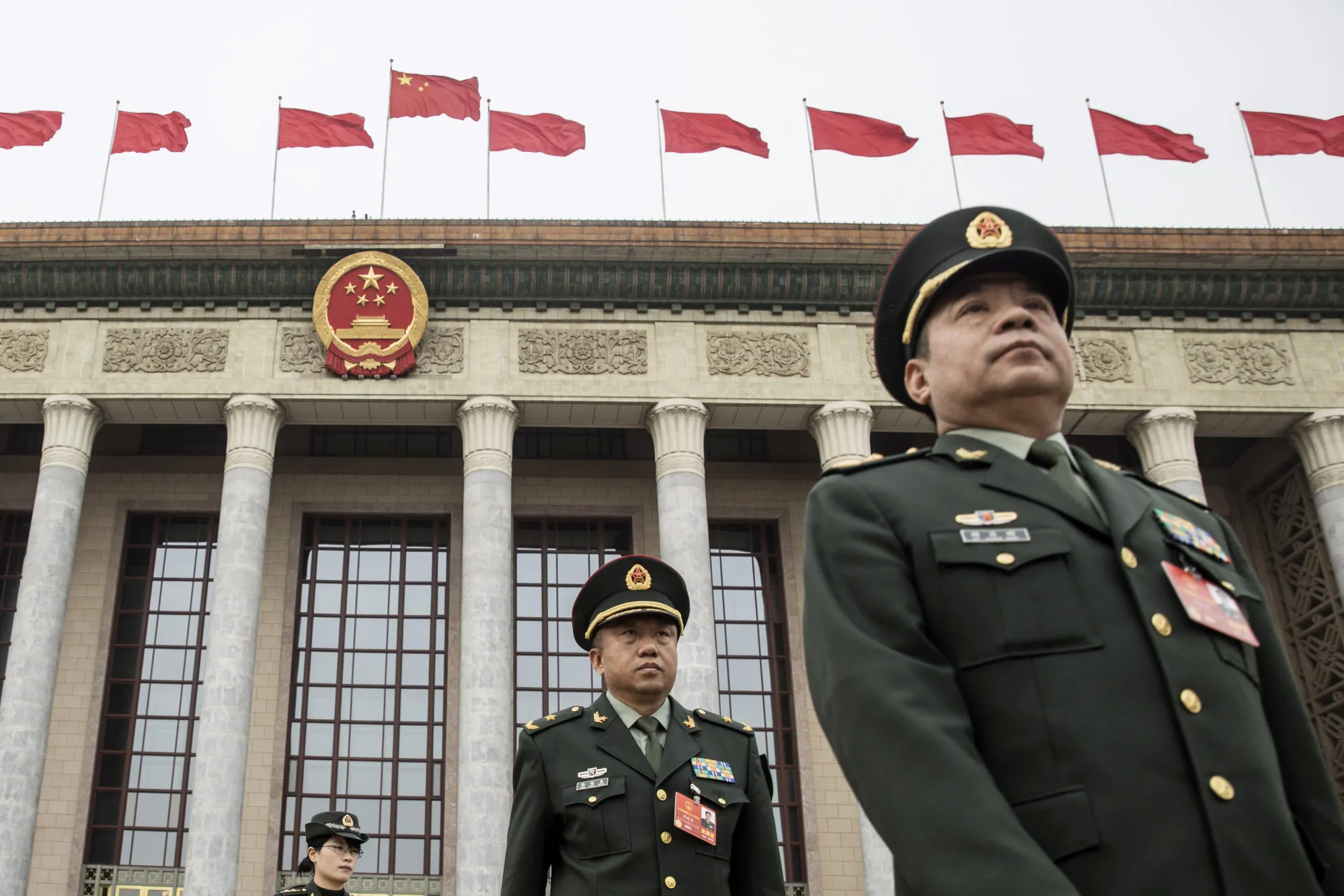 Military delegates leave the Great Hall of the People following a group session at the first session of the 13th Chinese People's Political Consultative Conference (CPPCC) in Beijing, China, on March 4.