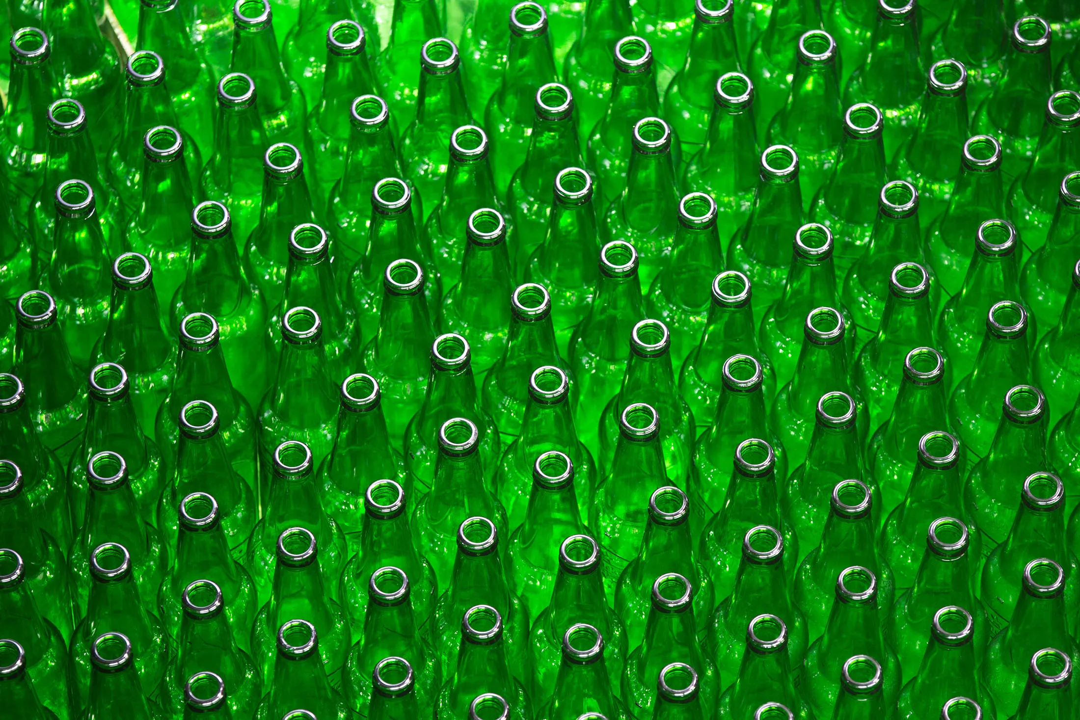 Empty bottles for Heineken beer move along the production line at the Heineken NV brewery in Saint Petersburg, Russia, on Wednesday, Nov. 18, 2015. Heineken reported estimate-beating sales growth boosted by a warm European summer as the world's third-largest brewer prepares to become a distant number two.
