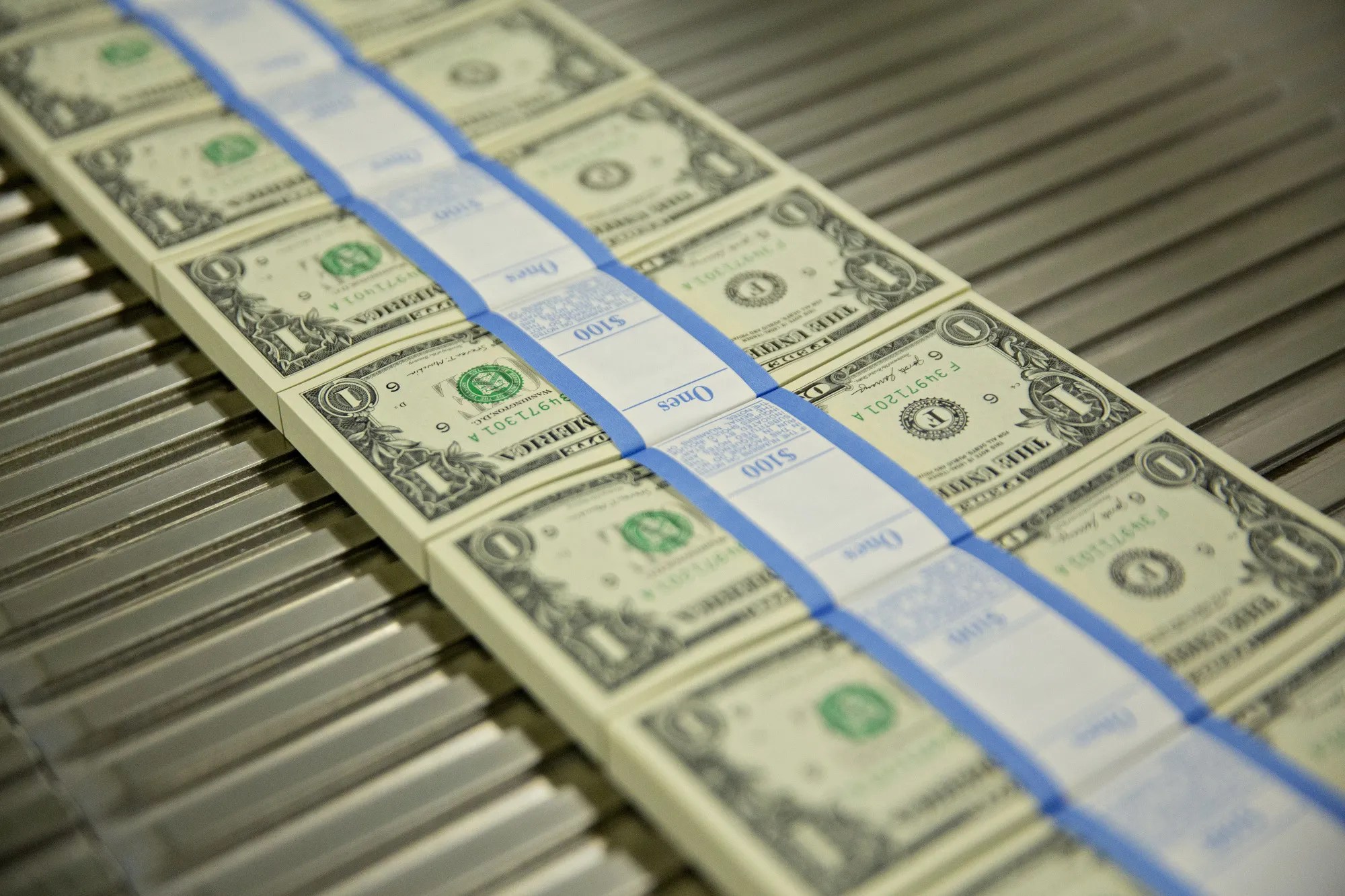 Stacks of $1 dollar notes&nbsp;move through a machine at the U.S. Bureau of Engraving and Printing in Washington, D.C.
