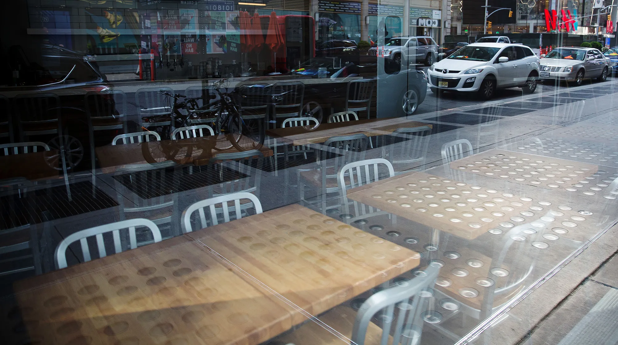 Chairs and tables sit inside a closed restaurant in Times Square in New York on April 21.