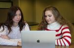 Kateryna Kravchenko (left) and Eva Malezhyk helped to translate application forms for Ukrainian-speaking asylum-seekers.